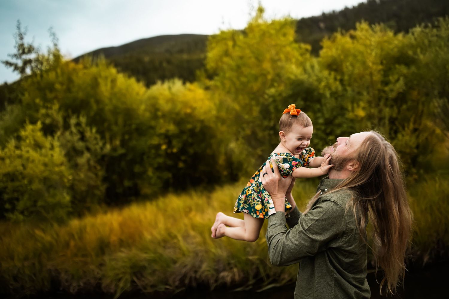 A series of outdoor photos showing playful interactions between parent and child in a natural setting.