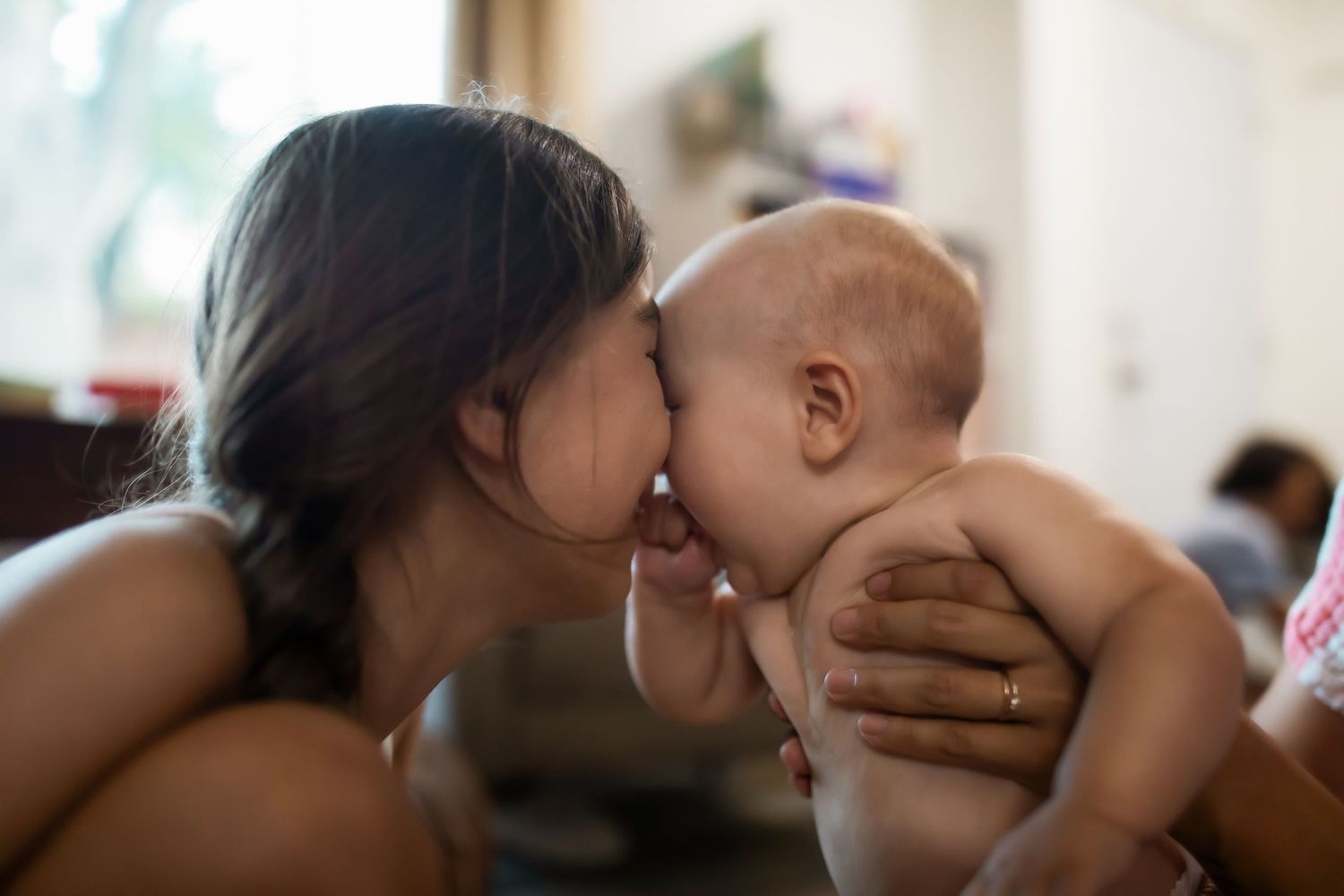 A tender moment between parent and baby in a collage of intimate close-up photos.