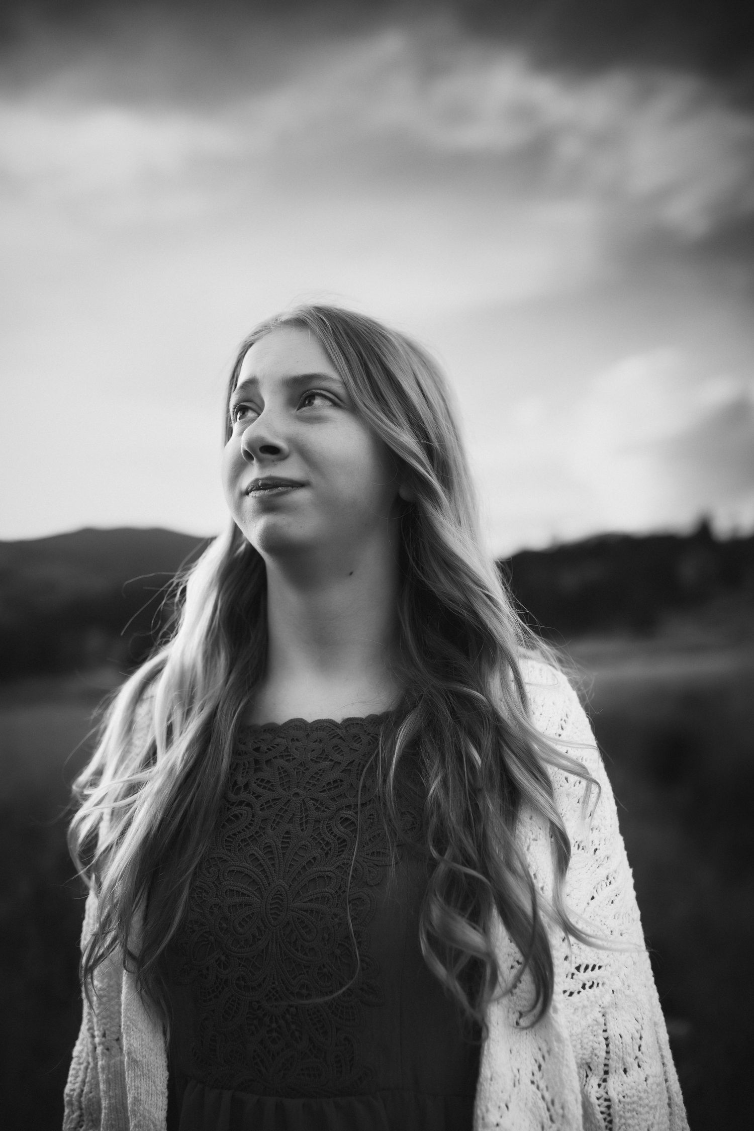 Artistic black and white portraits showing different angles of a person looking up at the sky.