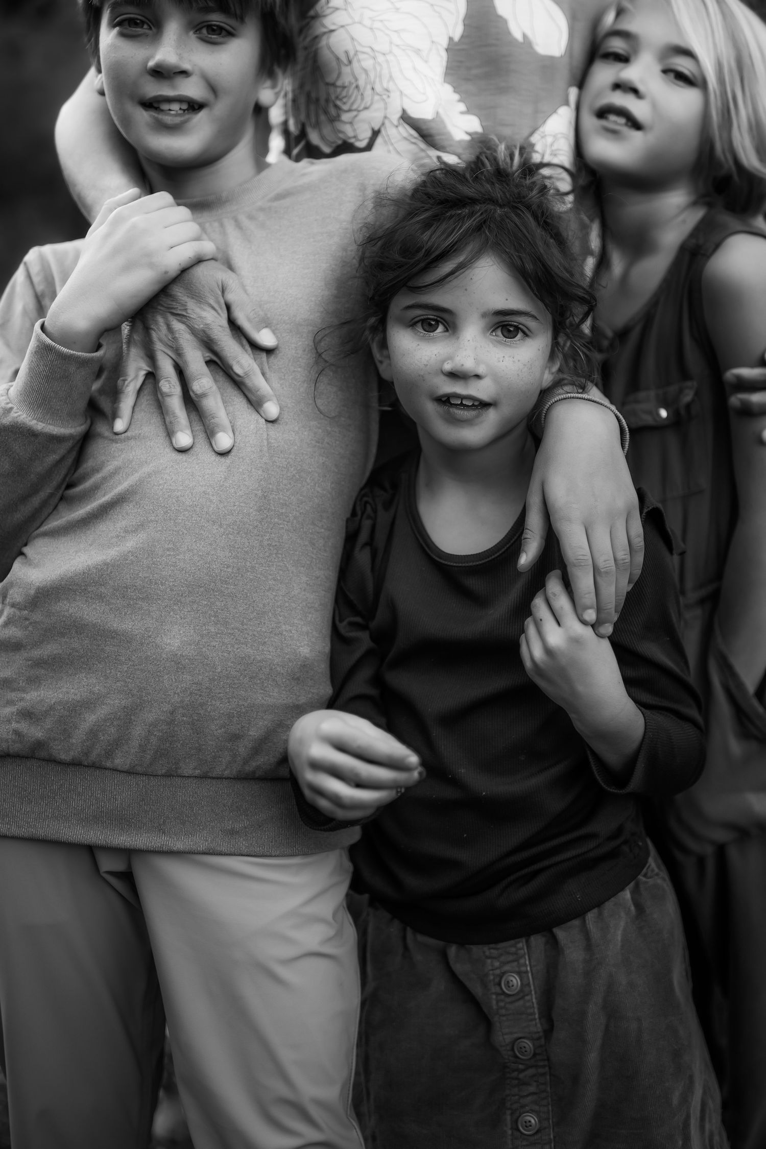 Group photo showing casual embraces and interactions in black and white.