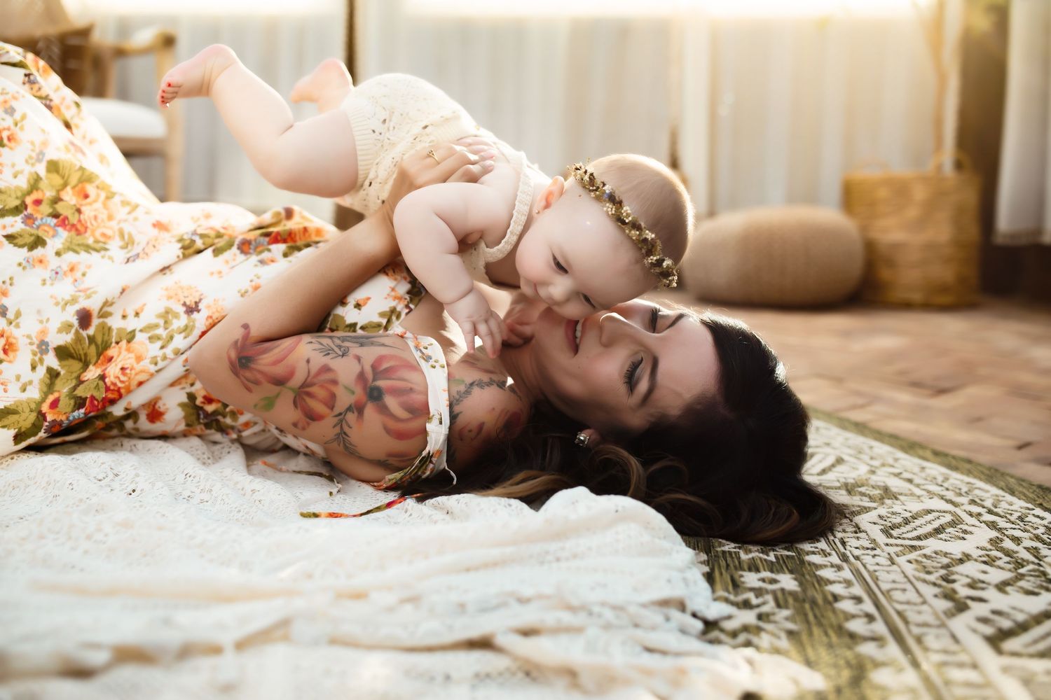 A tender moment shared between parent and child laying on a patterned rug in soft natural light.