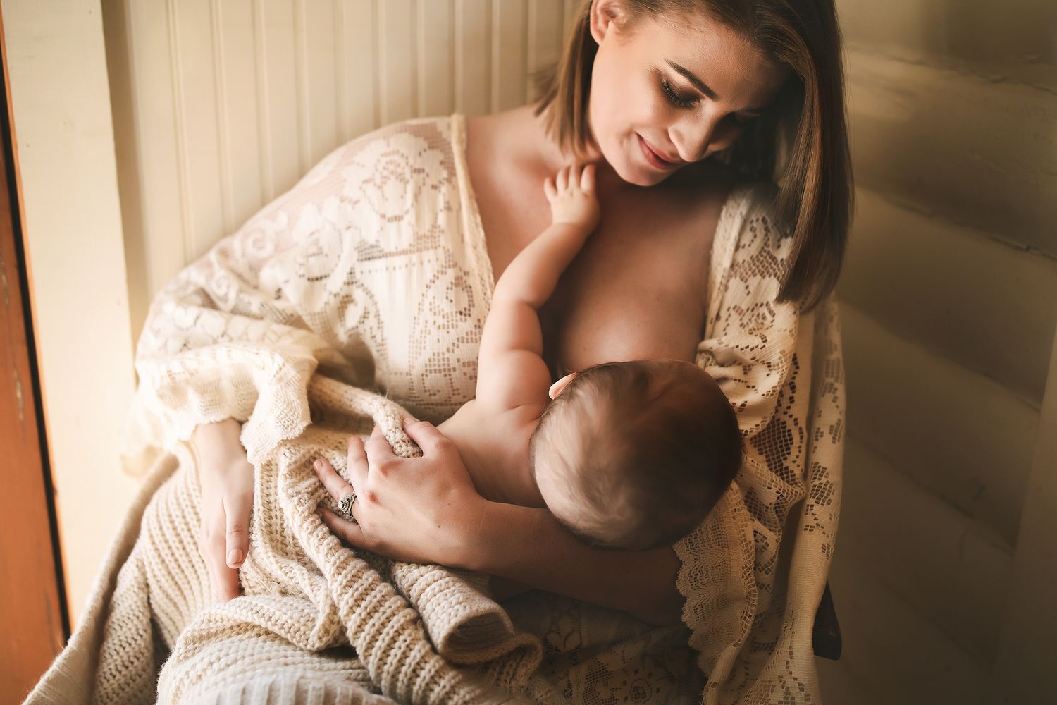 Family members embracing in soft natural window light.