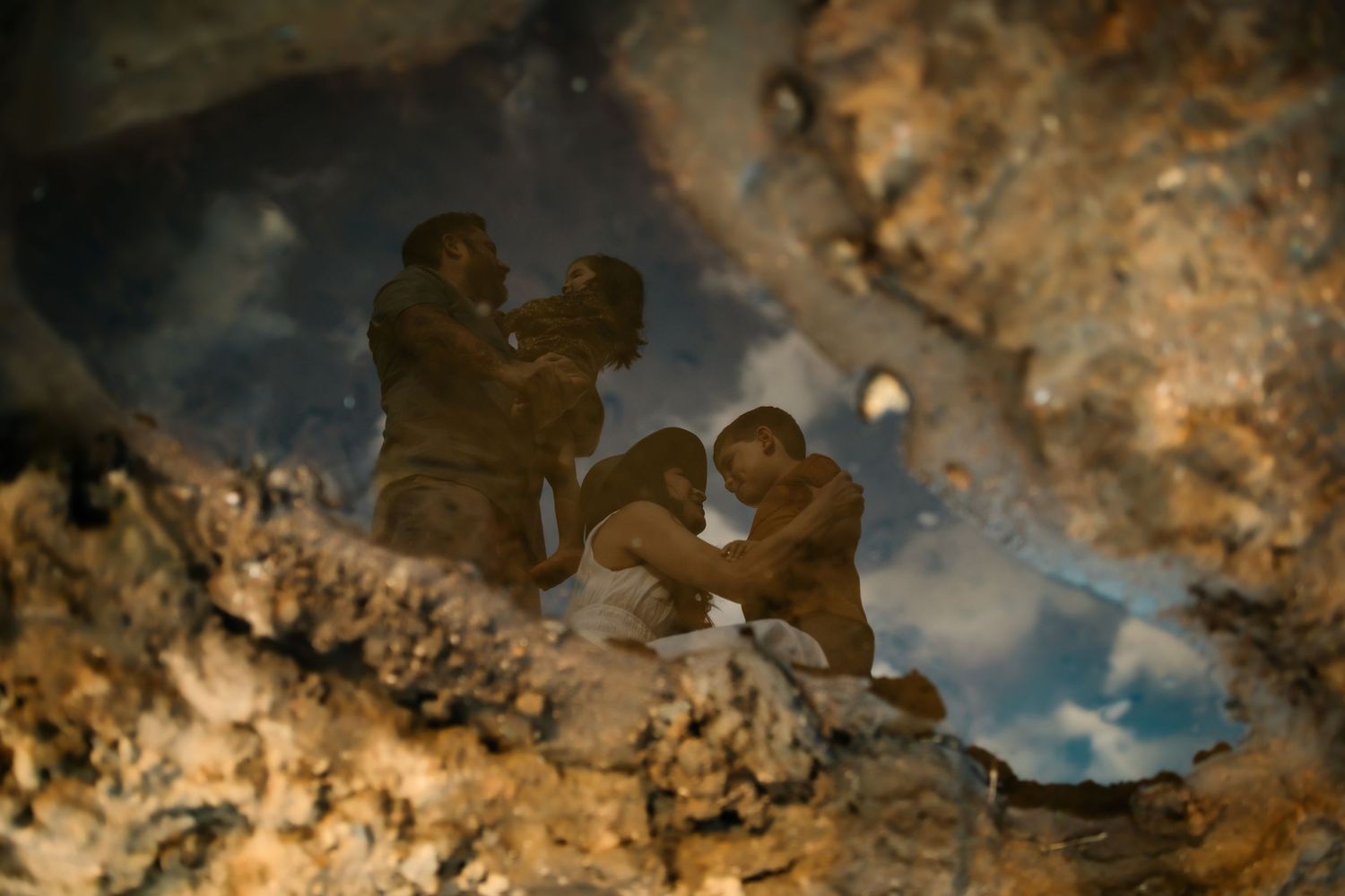 Abstract reflection of sky and clouds in dark water puddles.