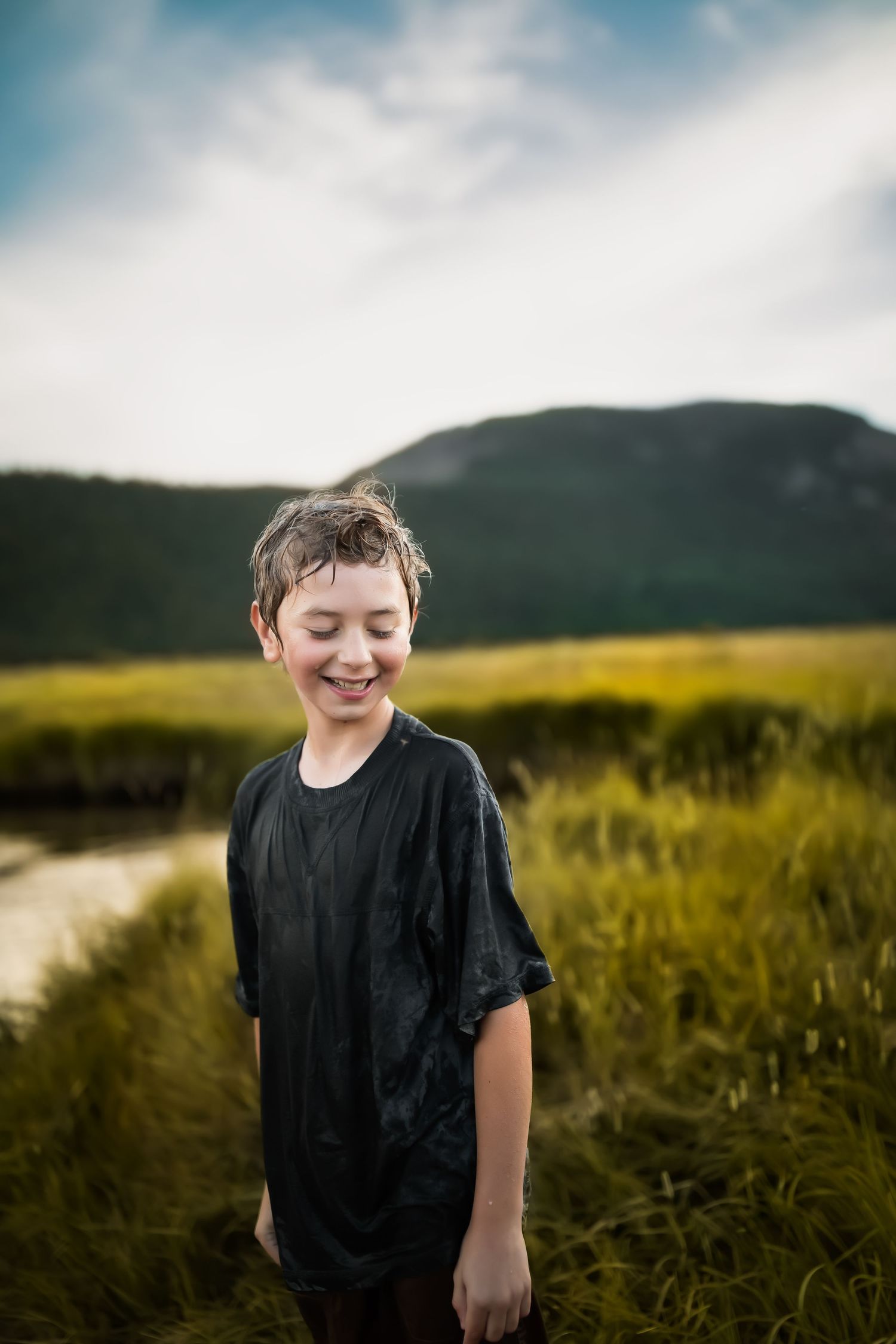 A joyful moment captured against rolling hills and mountains during sunset.