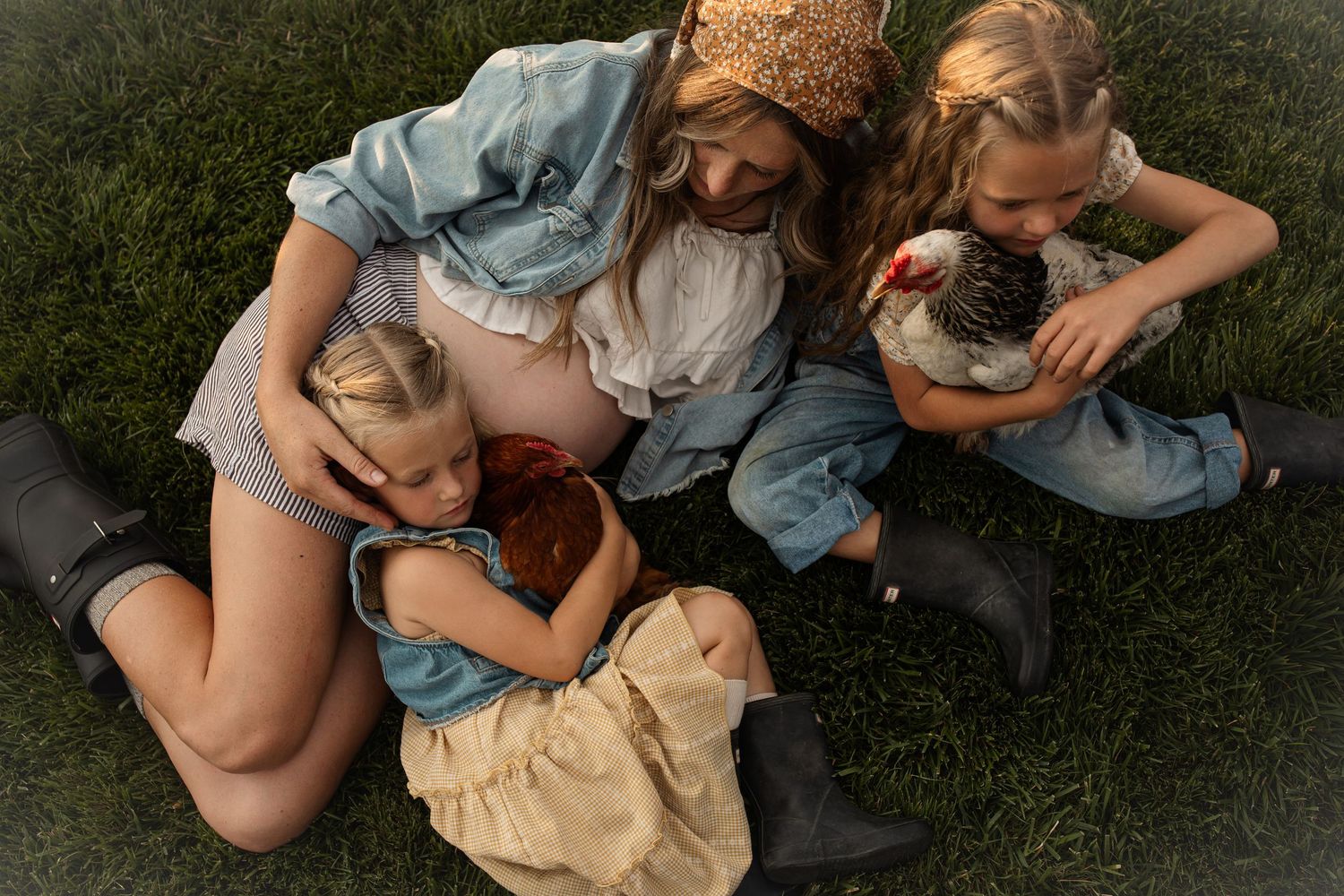 People lying on grass having intimate family moments in natural lighting.