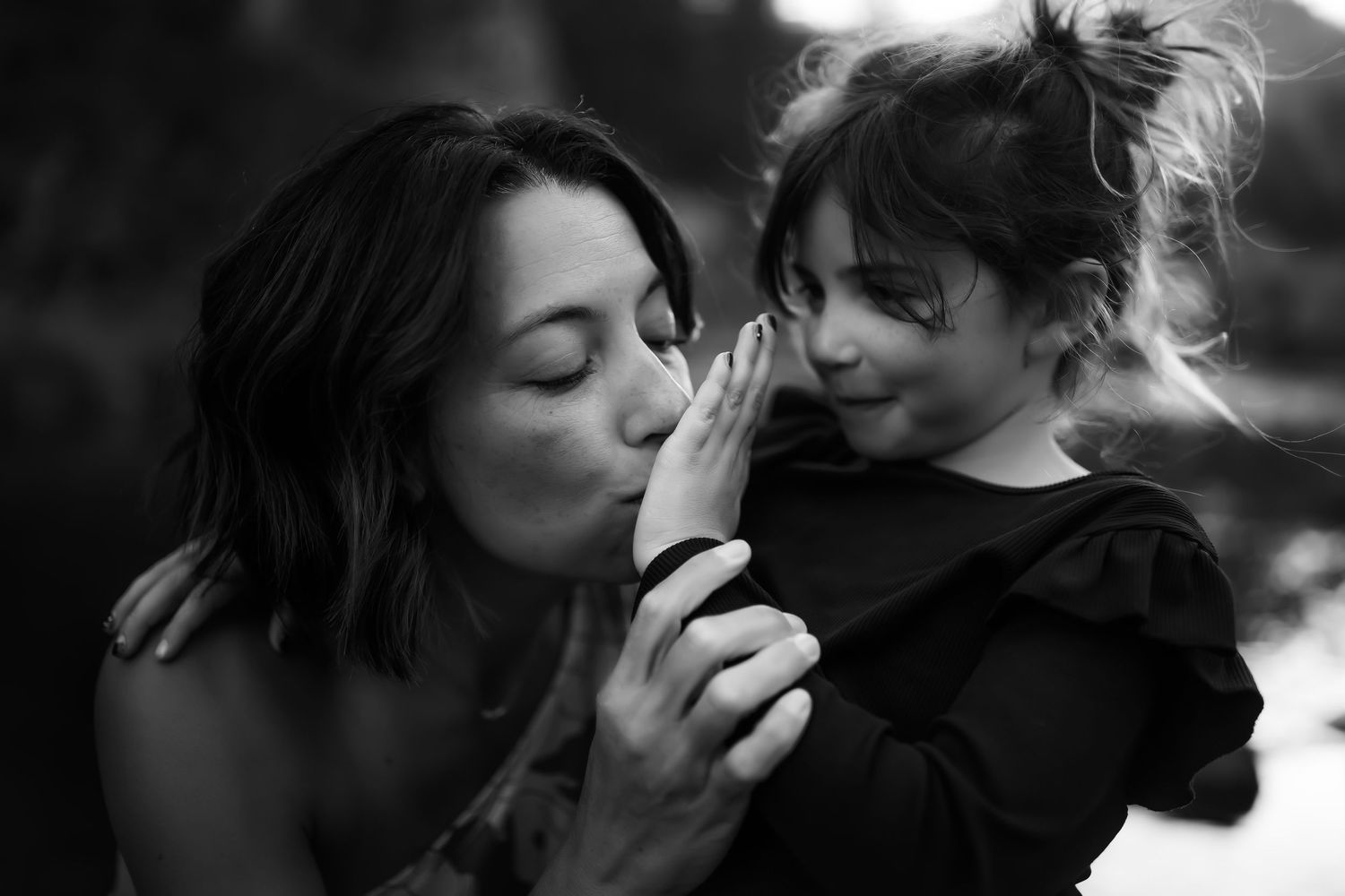 Intimate black and white portrait series showing tender moments between two people.