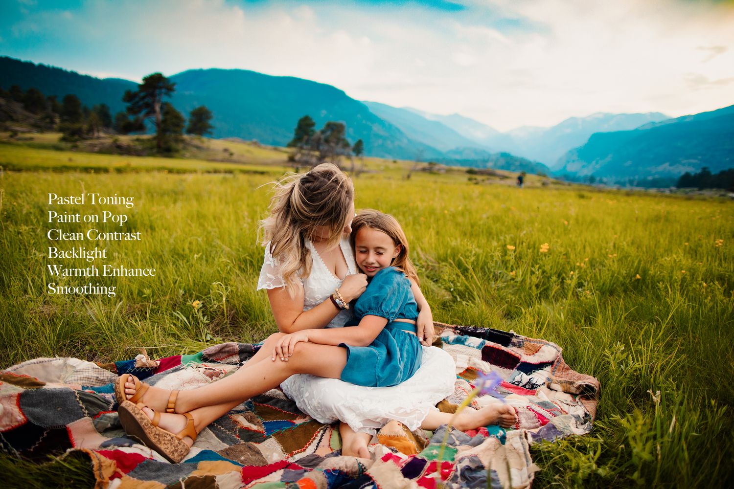 Couple sharing intimate moments on a blanket during sunset in a mountain field.