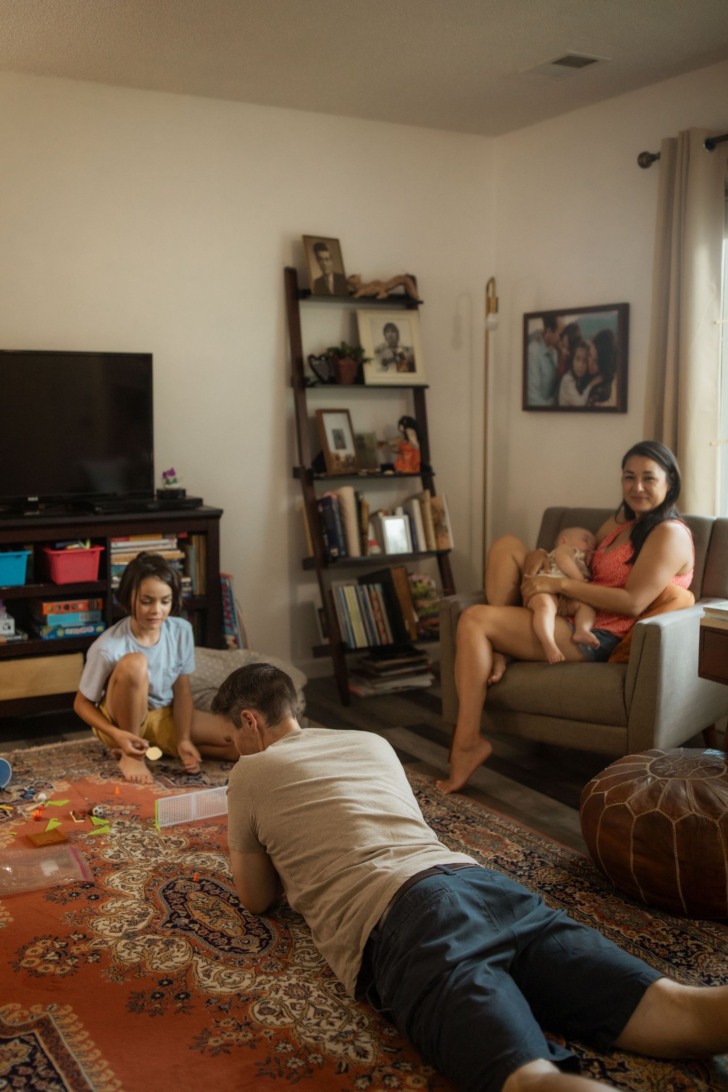 People working on a large jigsaw puzzle together on a patterned rug.