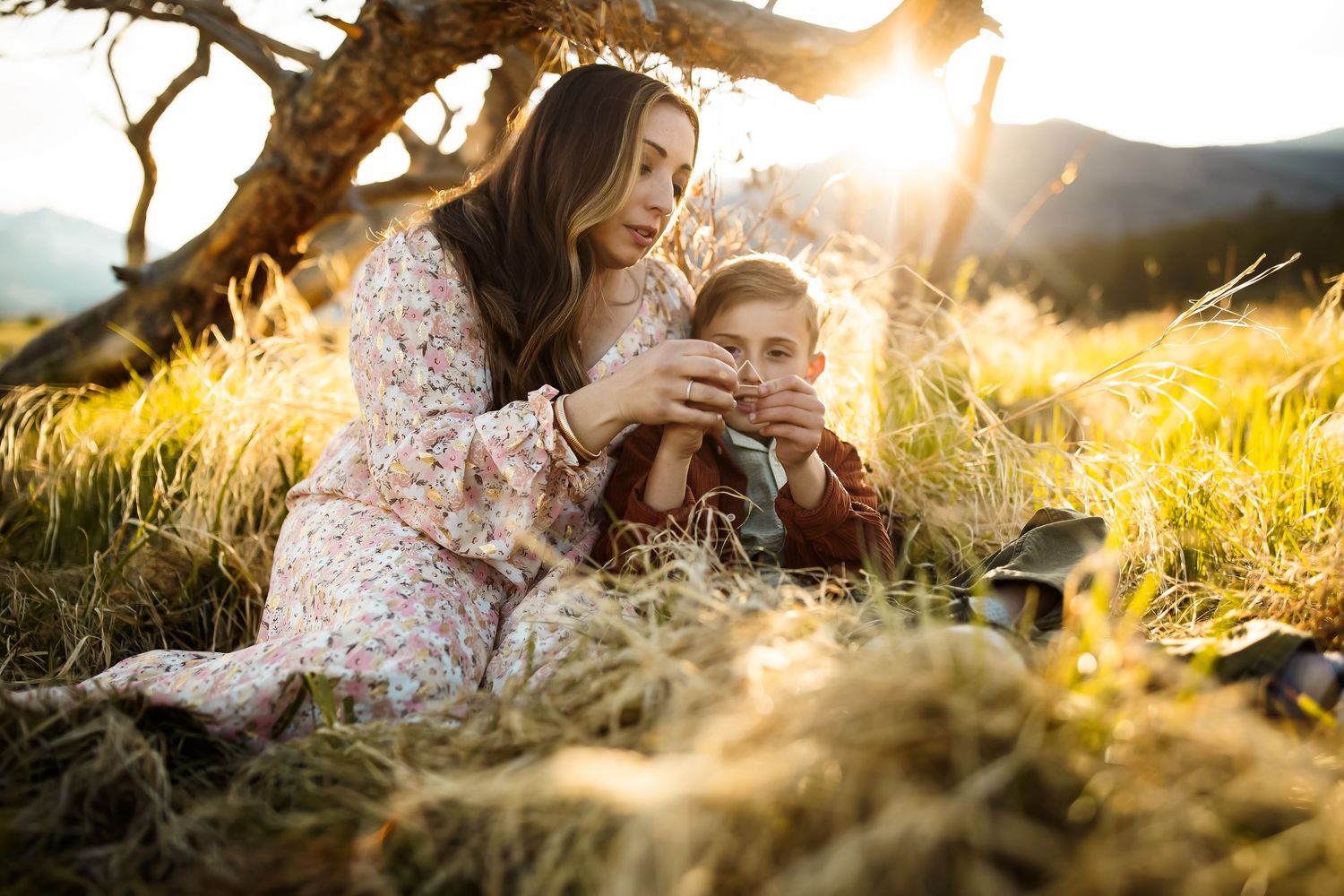 Romantic sunset photoshoot in a golden field with soft natural lighting.