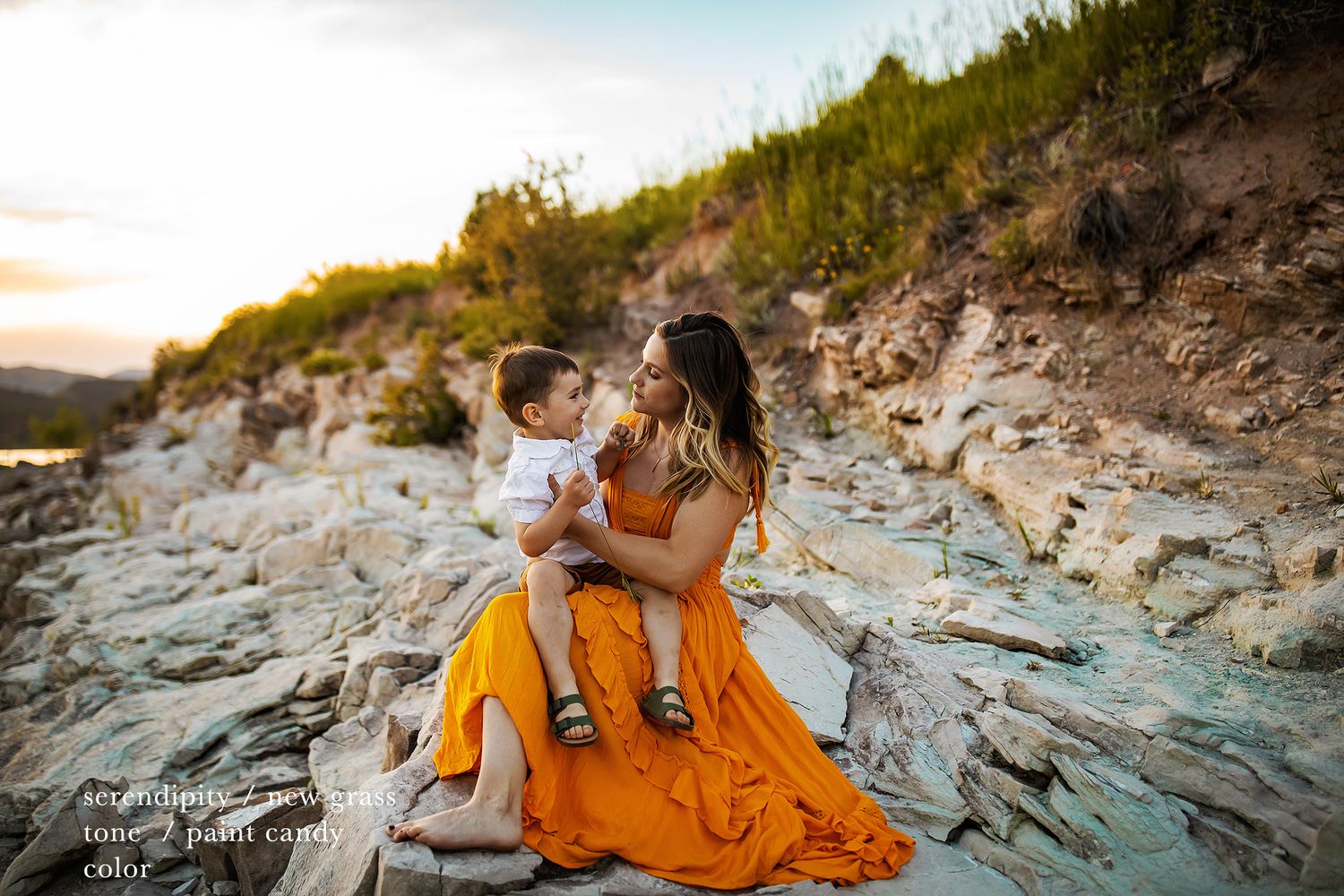 Candid family photography on rugged coastal rocks at golden hour.
