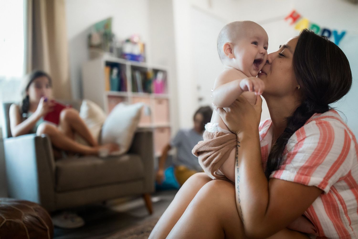 A series of candid moments showing a parent and baby bonding together in various tender interactions at home.