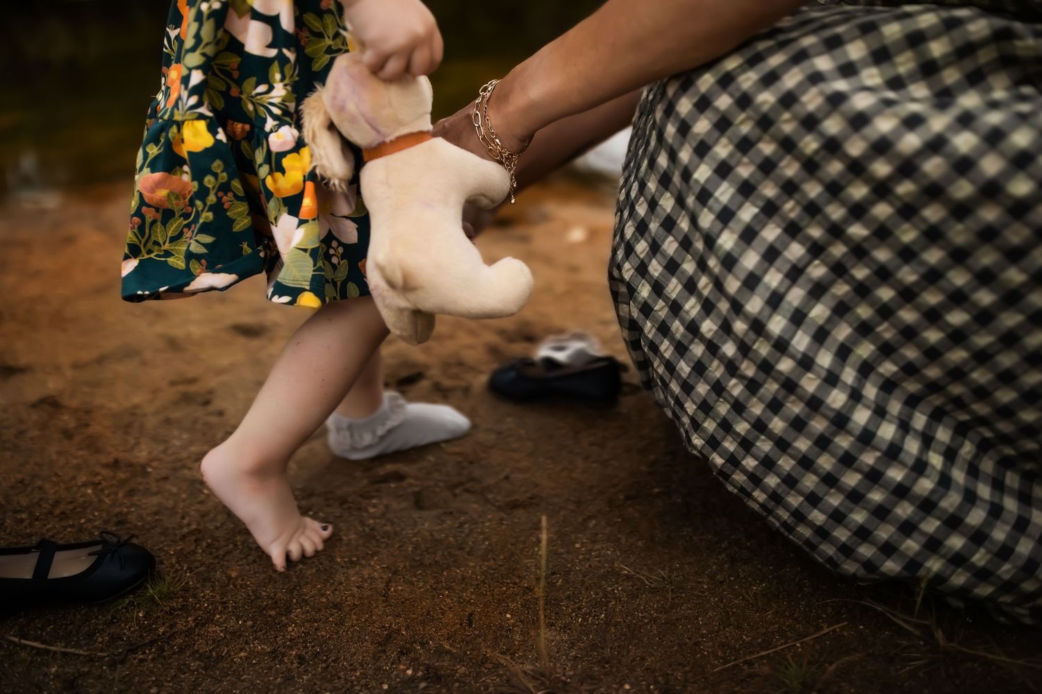 A sequence of images showing hands and feet walking on dirt ground with floral patterns visible in the background.