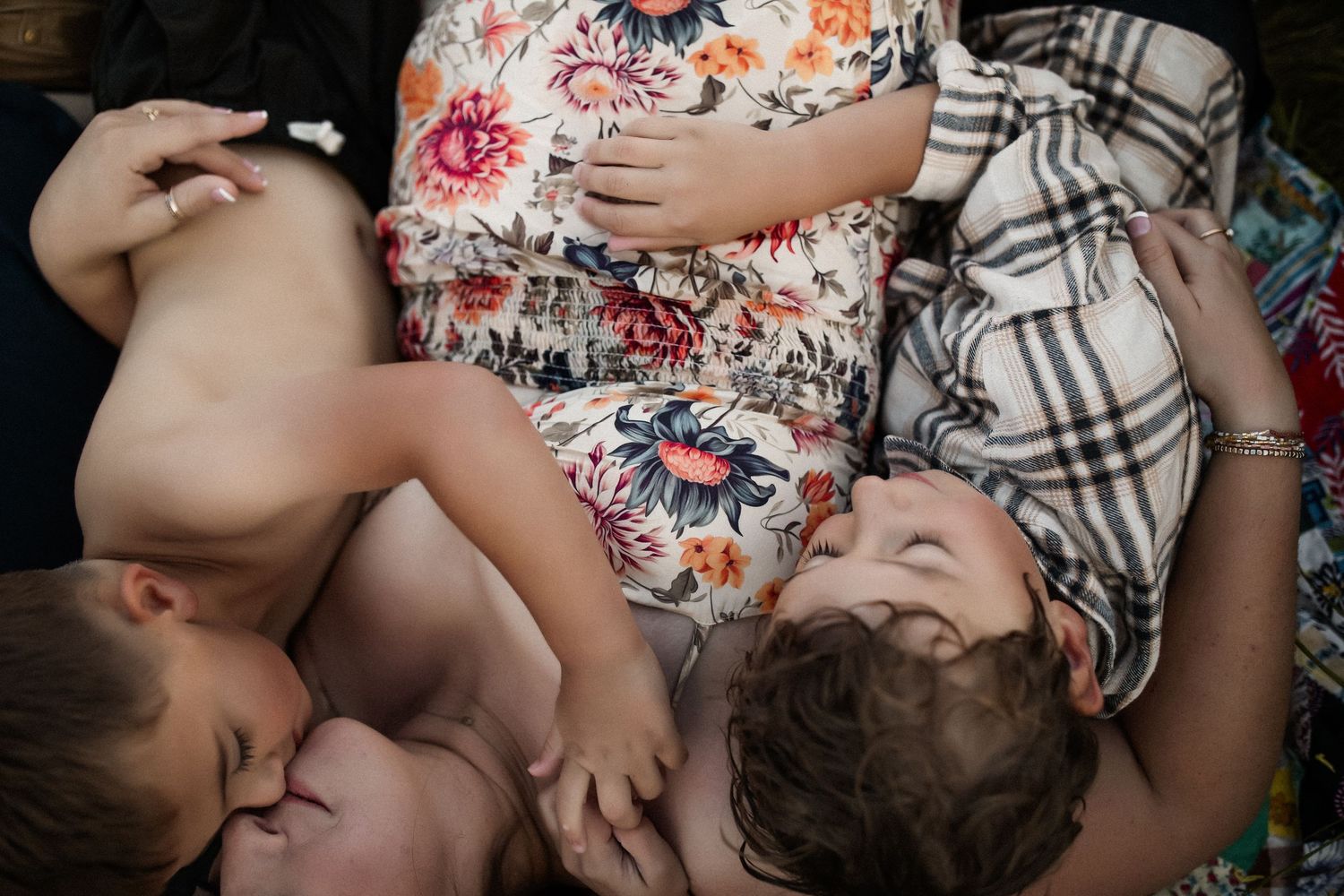 A collection of intimate family moments showing hands and feet touching in a series of black and white photographs.