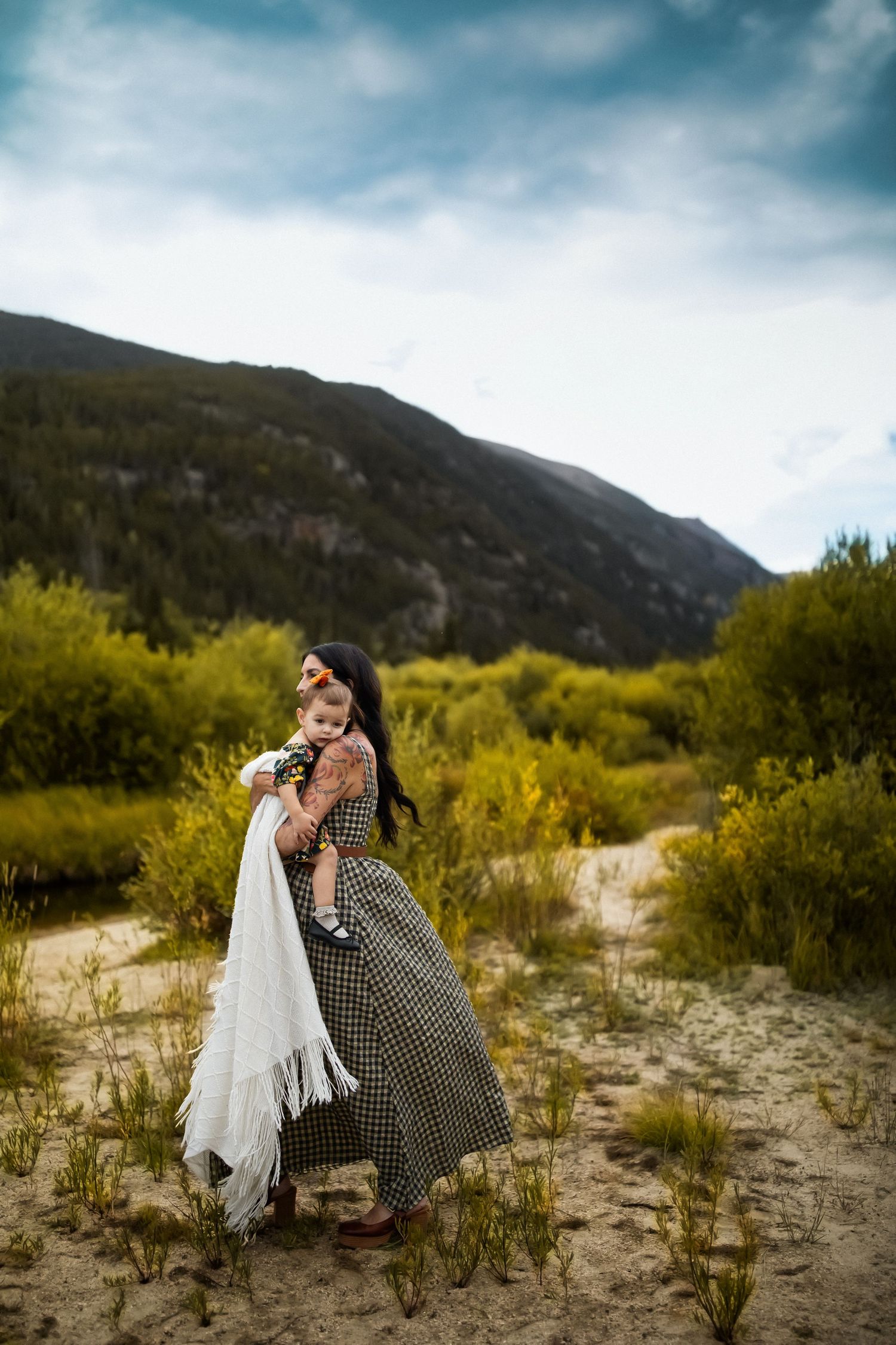 A heartwarming embrace captured against dramatic mountain scenery and autumn colors.