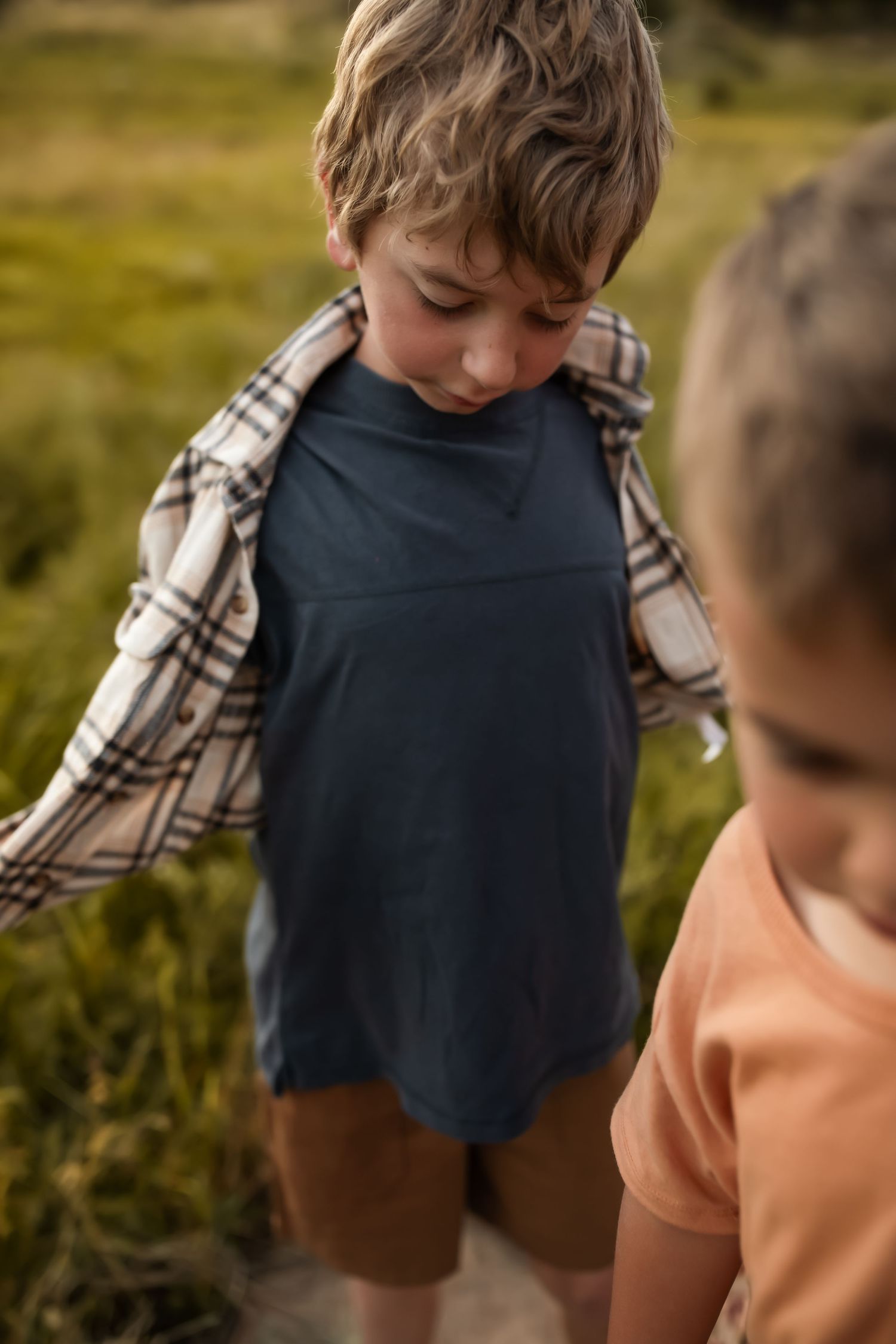 Close up detail of plaid and navy clothing textures in natural lighting.
