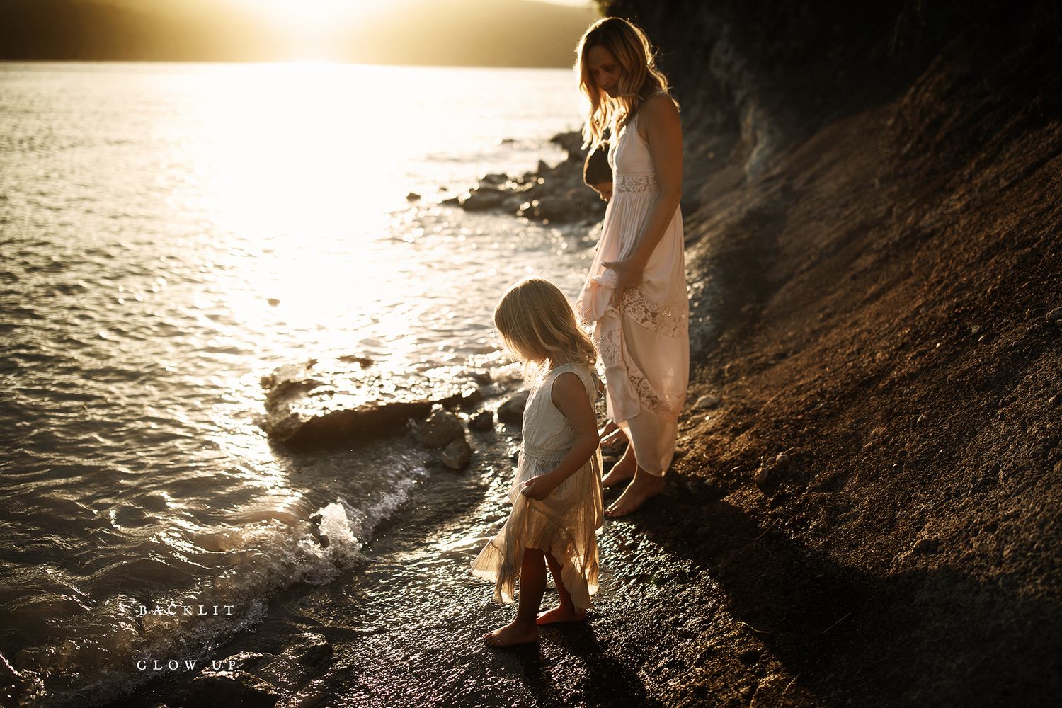 Artistic silhouette photography of people by the water's edge at sunset.