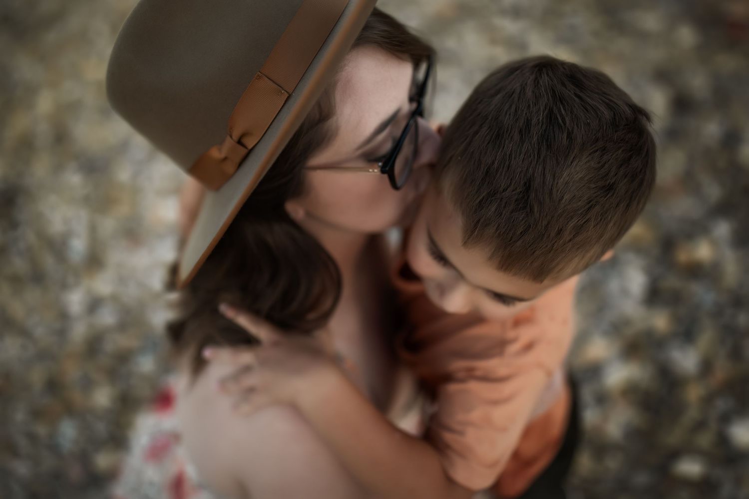 Intimate close-up portrait of couple outdoors with soft natural lighting.