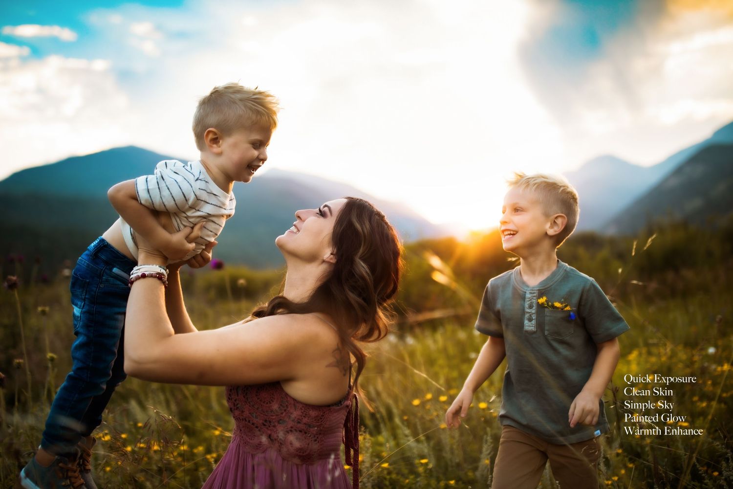Joyful outdoor family moment captured against mountain backdrop in golden sunlight.
