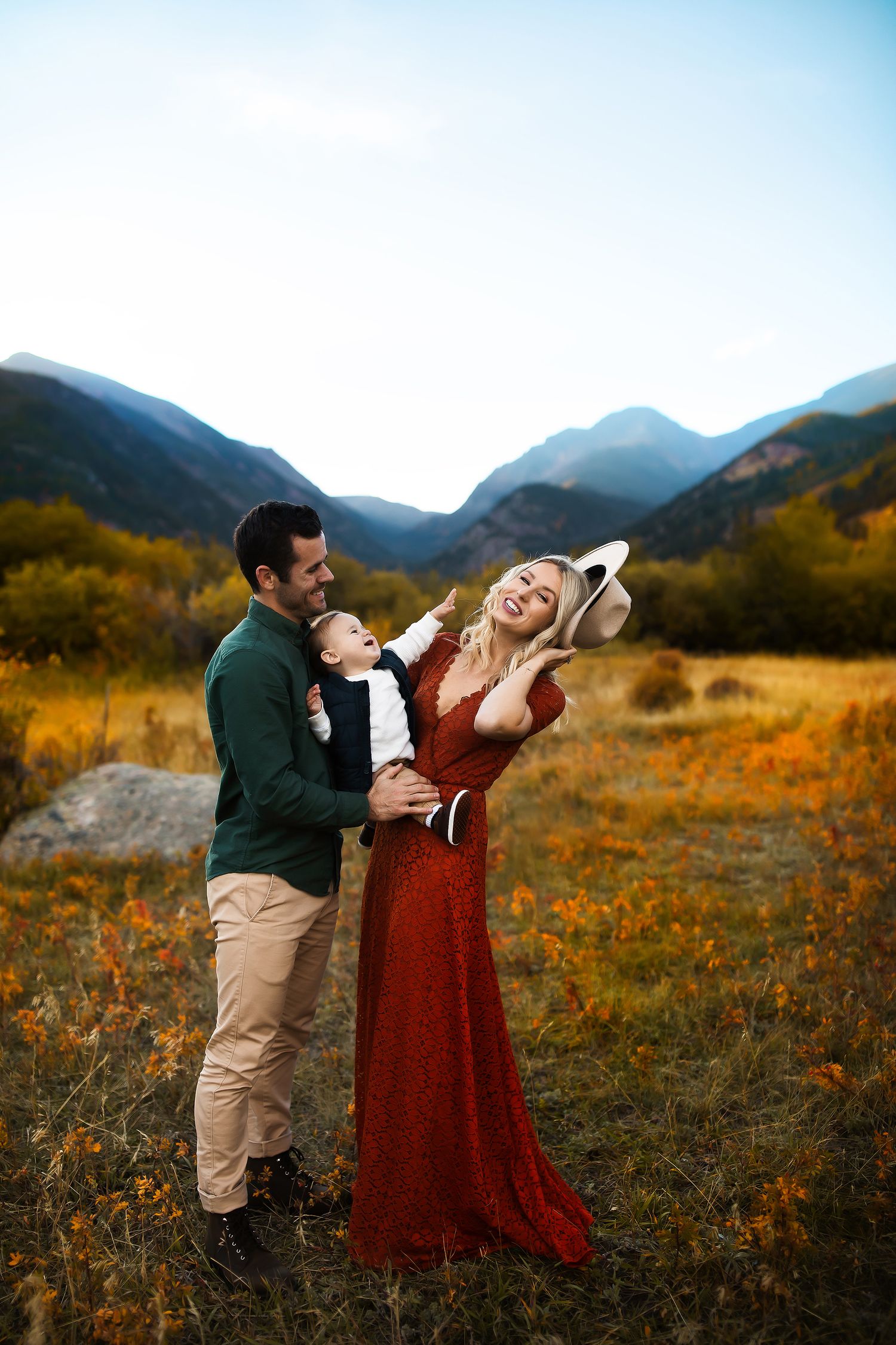 Couple shares romantic moments in a mountain meadow filled with wildflowers.