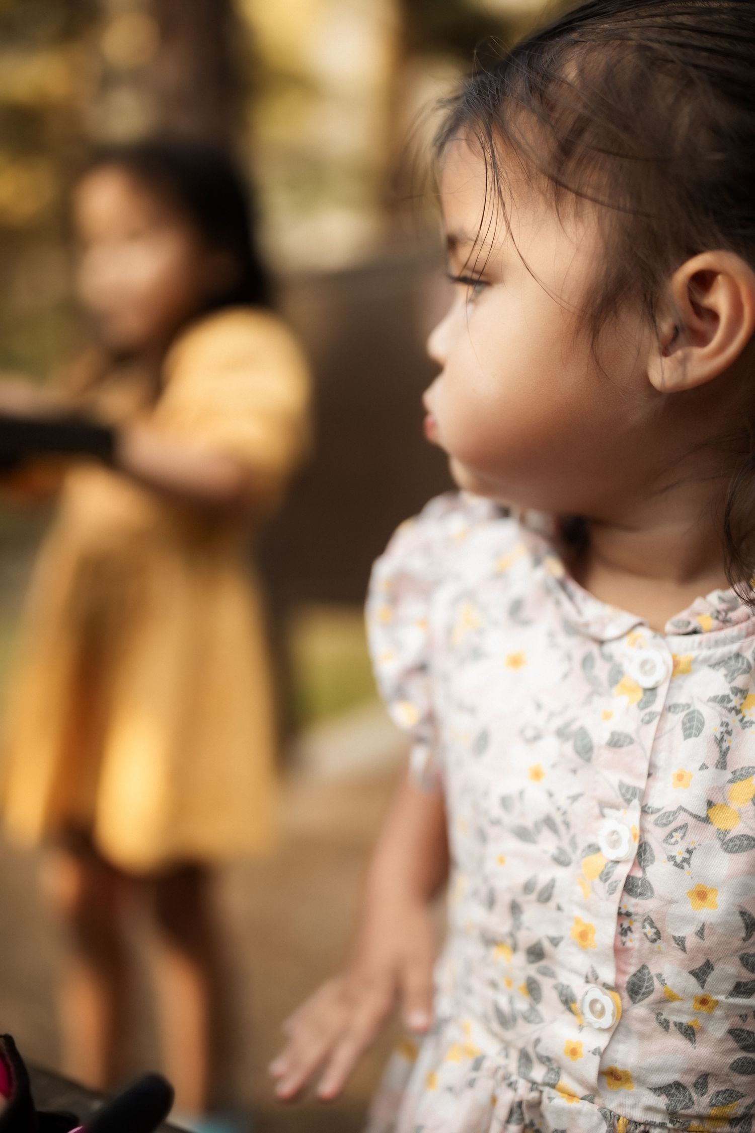 Side profile shots of a floral dress detail in soft focus.