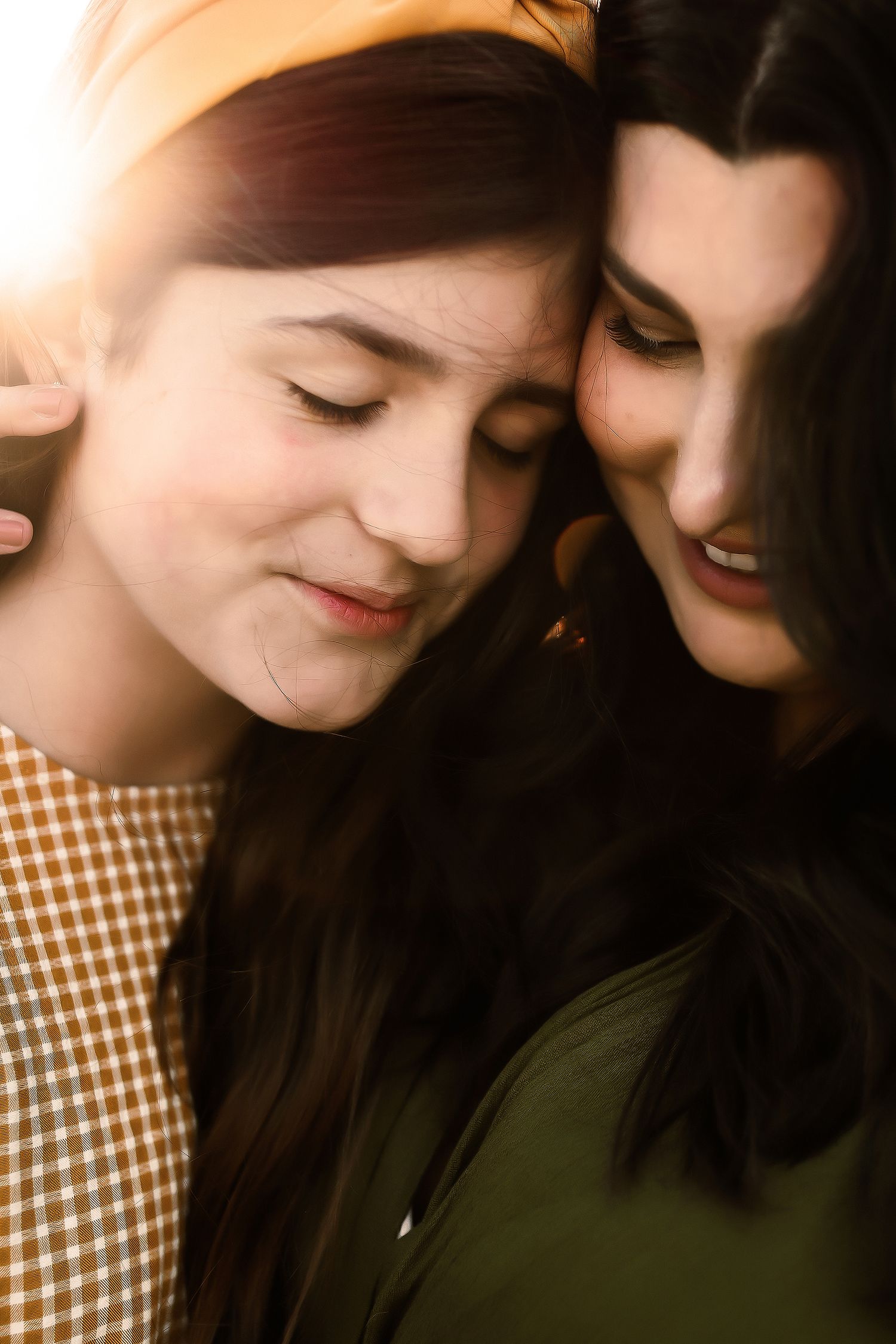 Close up portrait of a couple sharing an intimate moment in warm lighting.