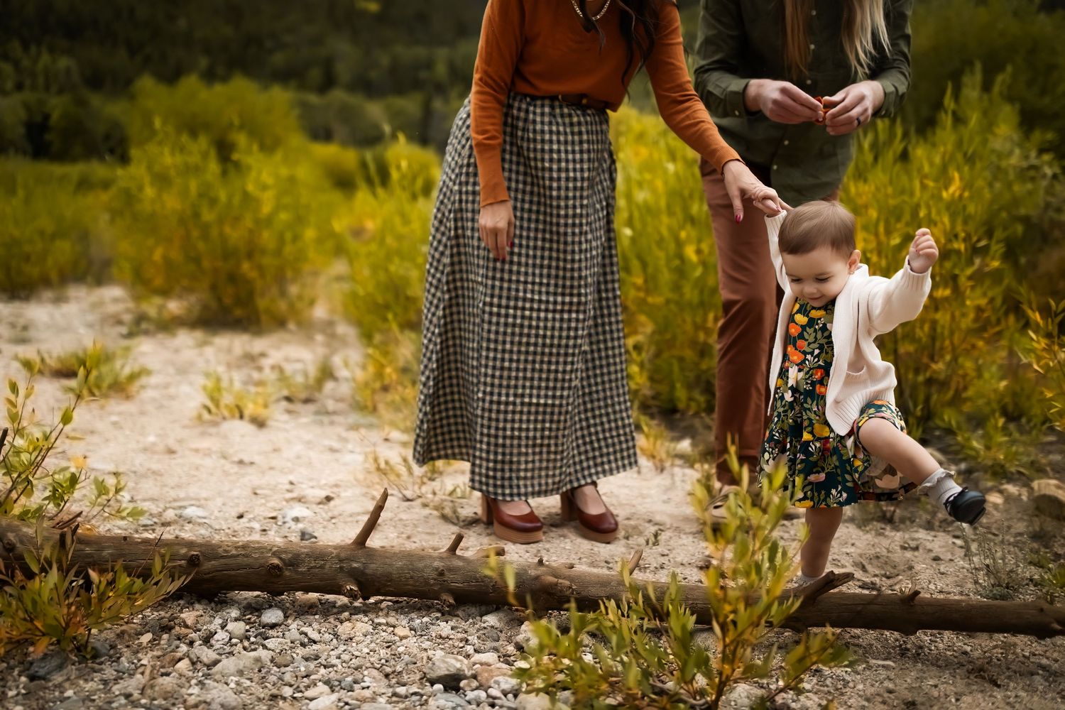 People's feet and legs shown walking along a rocky natural path.