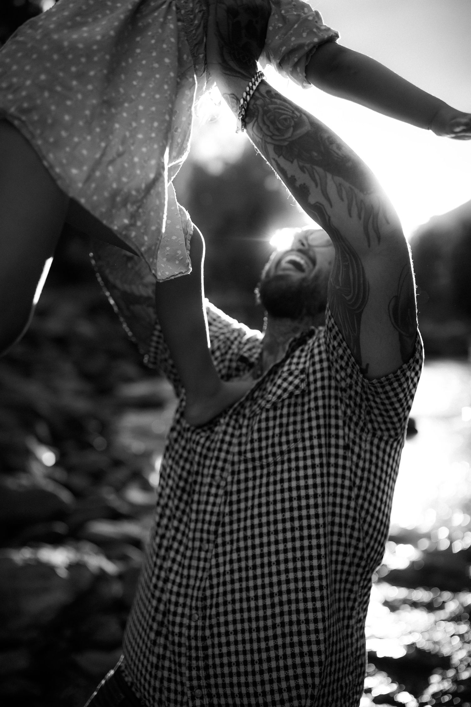 Black and white portrait with dramatic backlighting and gingham pattern clothing.