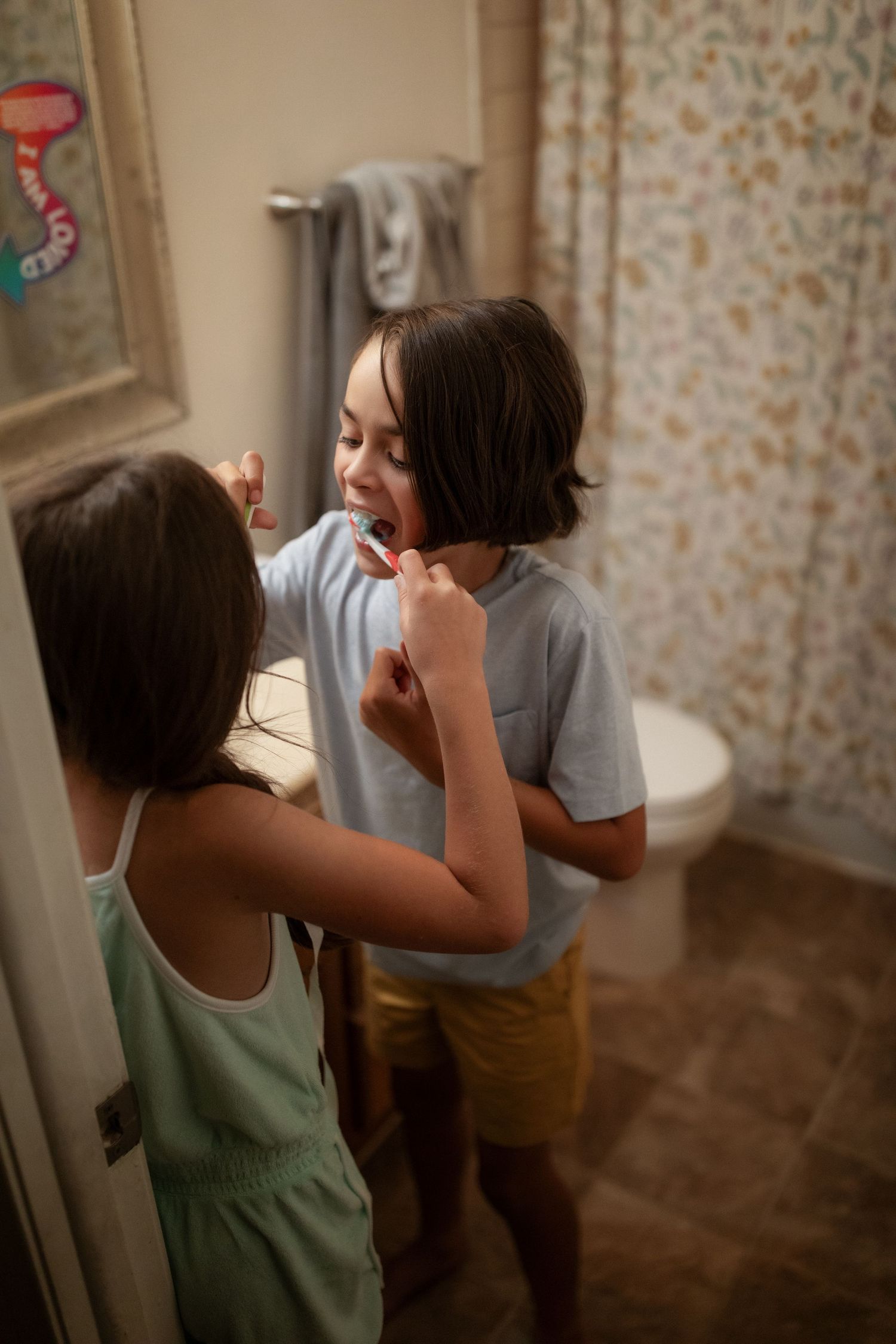 A series of four sequential images showing someone brushing teeth at a bathroom sink.