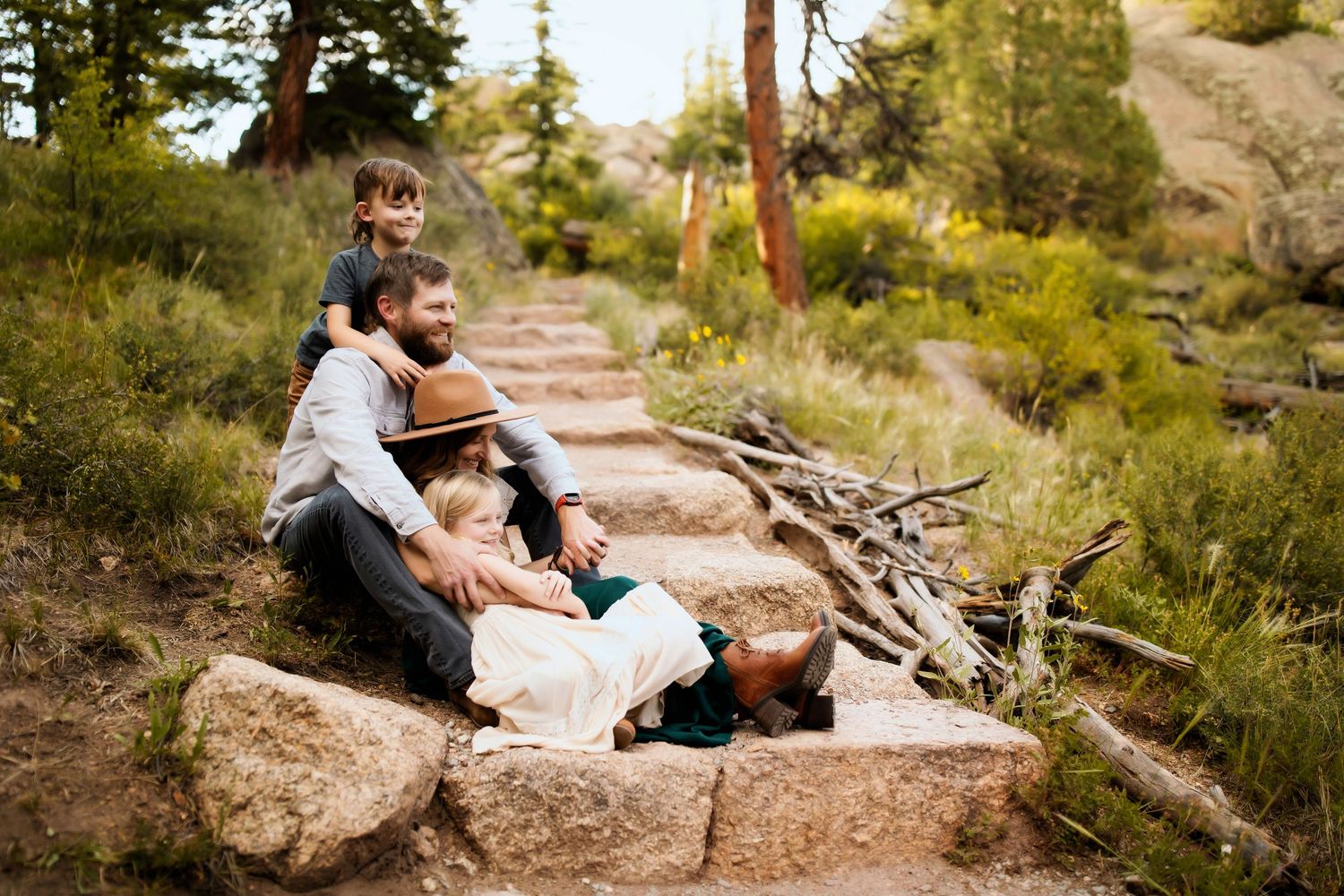 Natural outdoor portraits taken on rocky terrain with mountain scenery in the background.