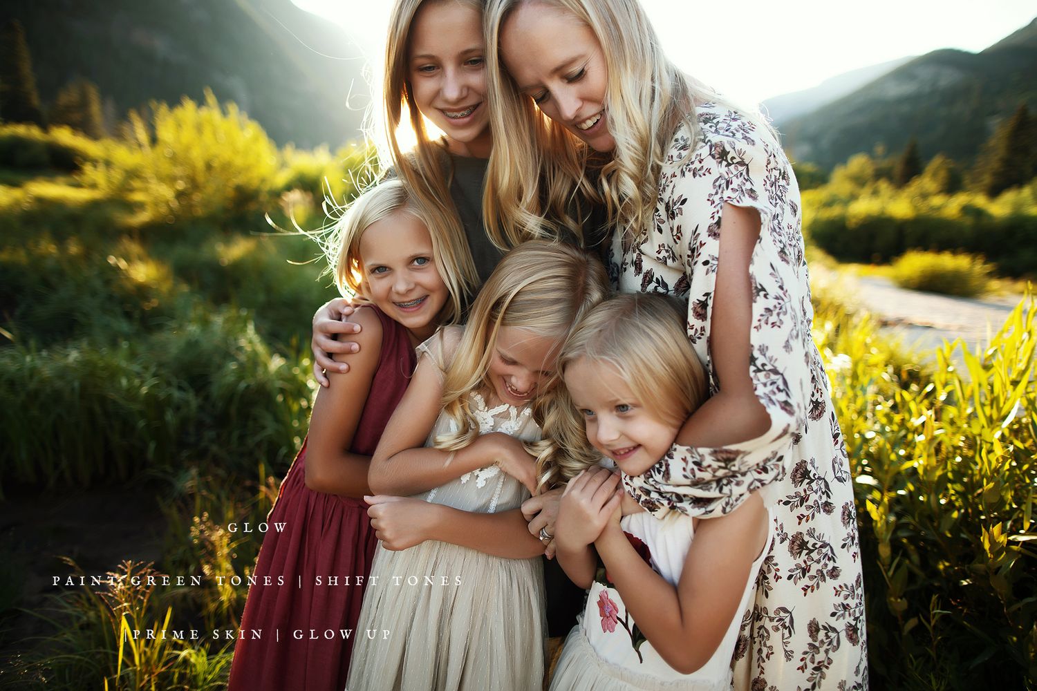 Group enjoying a summer evening in a wildflower field with mountain backdrop.