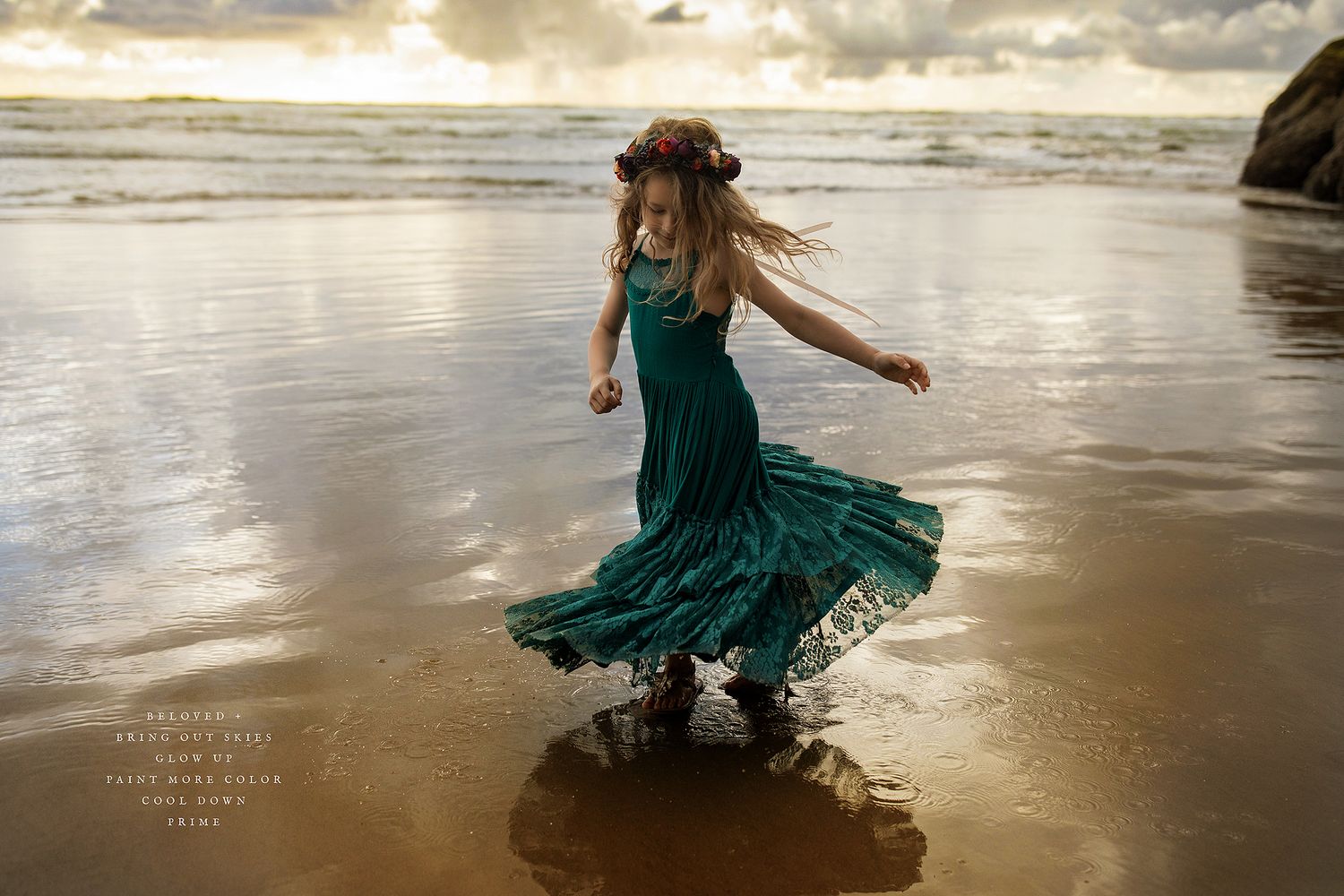 Artistic beach photography with figure in emerald dress against golden sunset waters.