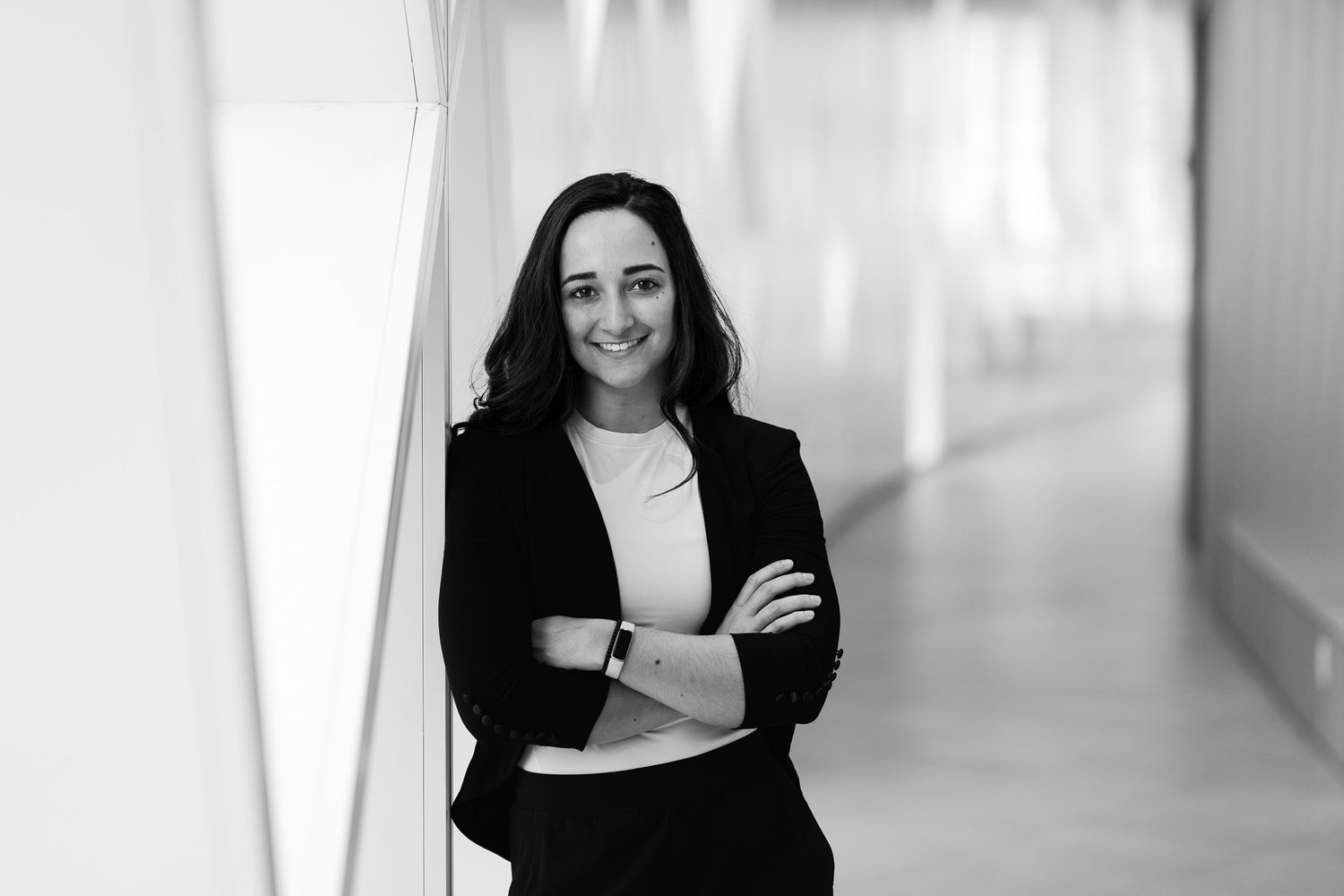 Professional headshots of person in business attire in modern office setting.