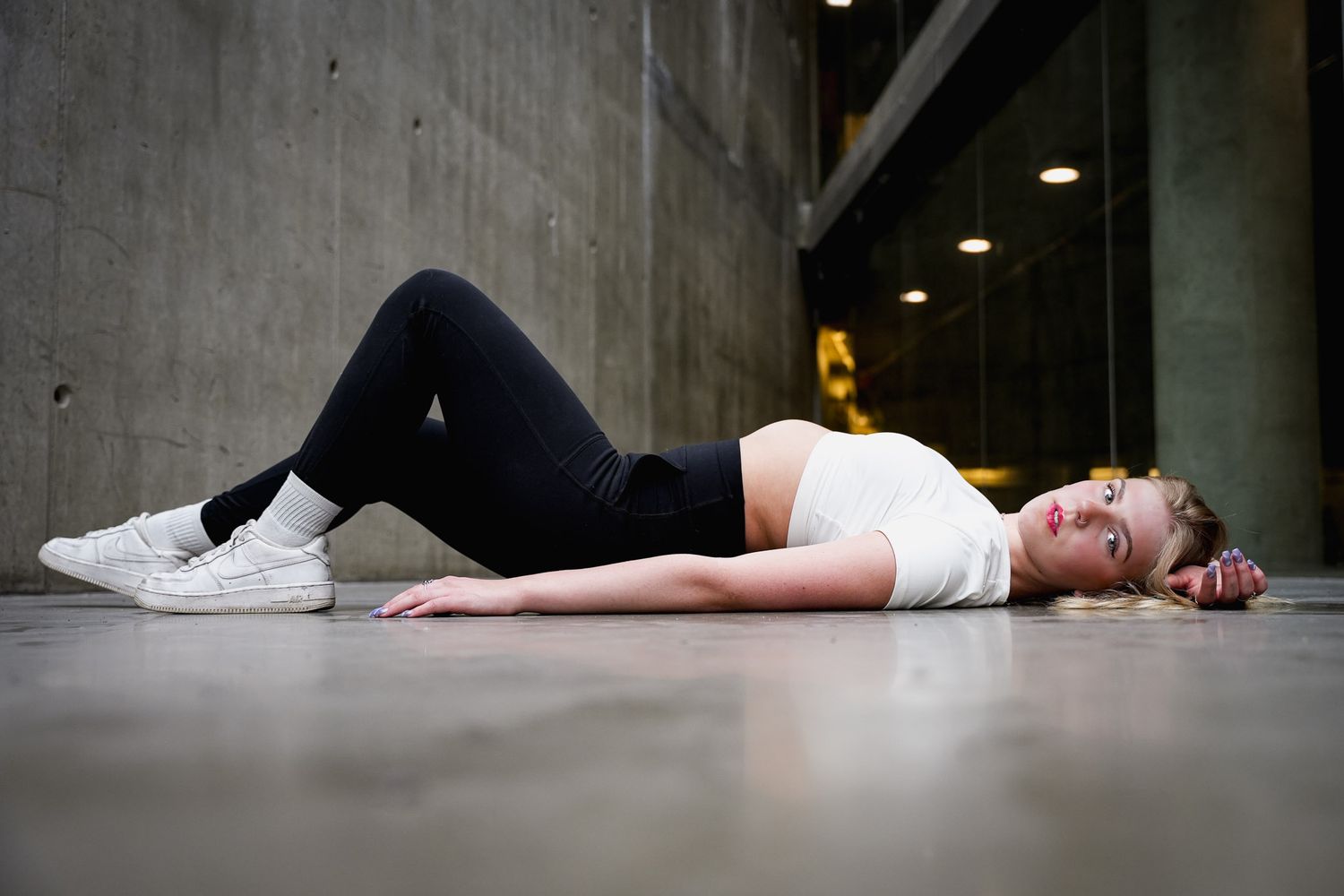 Contemporary dance poses performed on concrete floor with dramatic lighting.