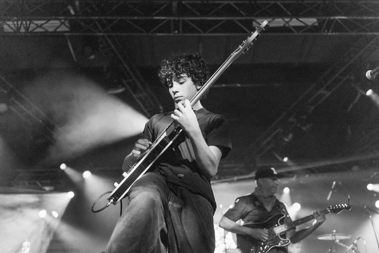 Black and white concert photo showing energetic stage performance by Roman Morello