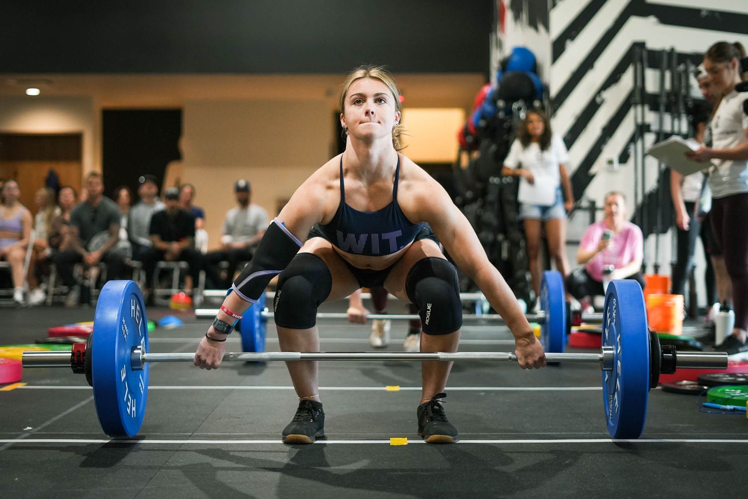 Sequence showing proper form for barbell deadlift exercise on gym floor.