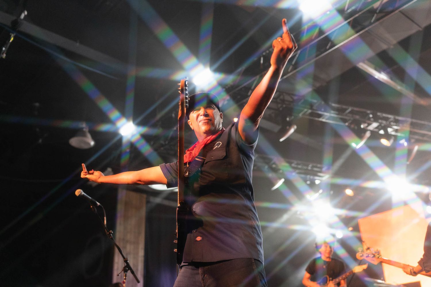 Tom Morello silhouetted against bright white spotlights during dynamic concert performance during the Calgary Stampede at the Roadhouse