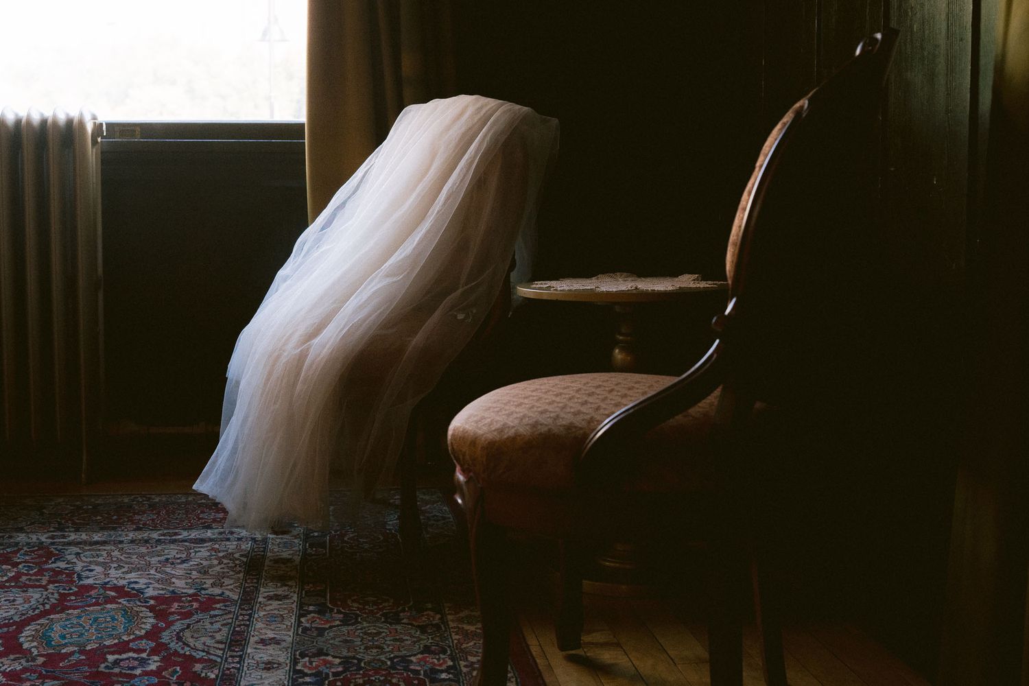 Artistic silhouettes of wedding couple in dramatic window lighting.