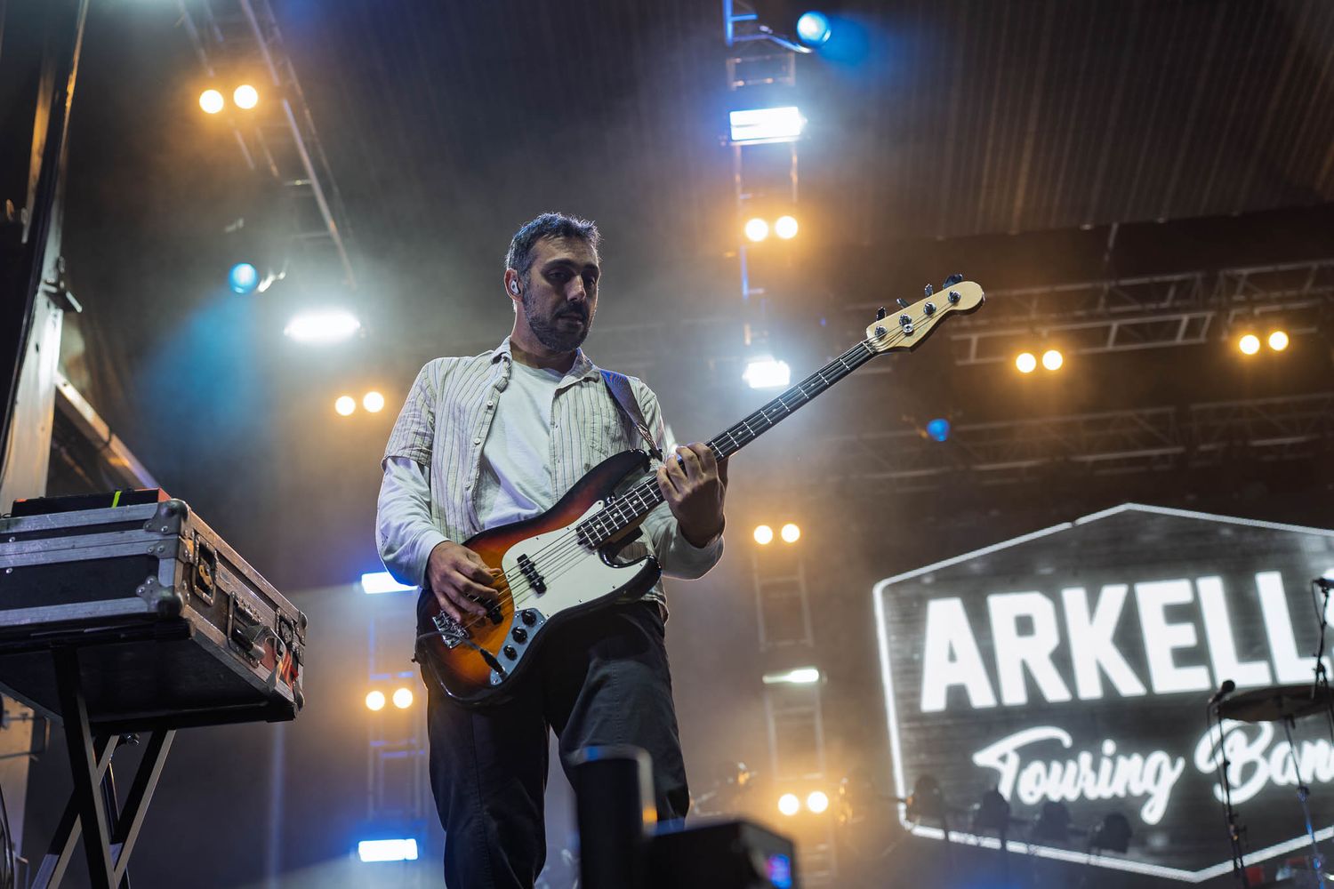 Concert stage setup with Arkells band name visible in bright lights.