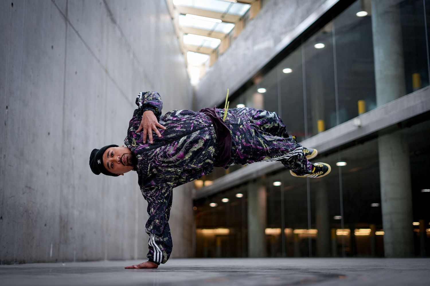 Dynamic parkour sequence showing person in black performing aerial moves in urban setting.