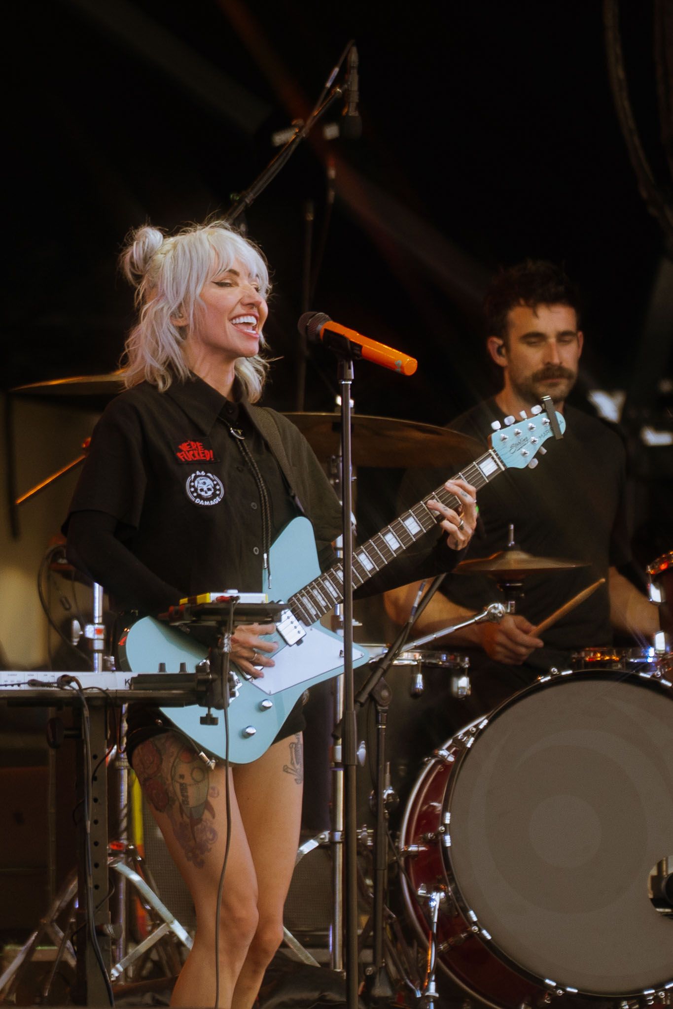 Band Lights performing live on stage with drums and light blue guitar visible.