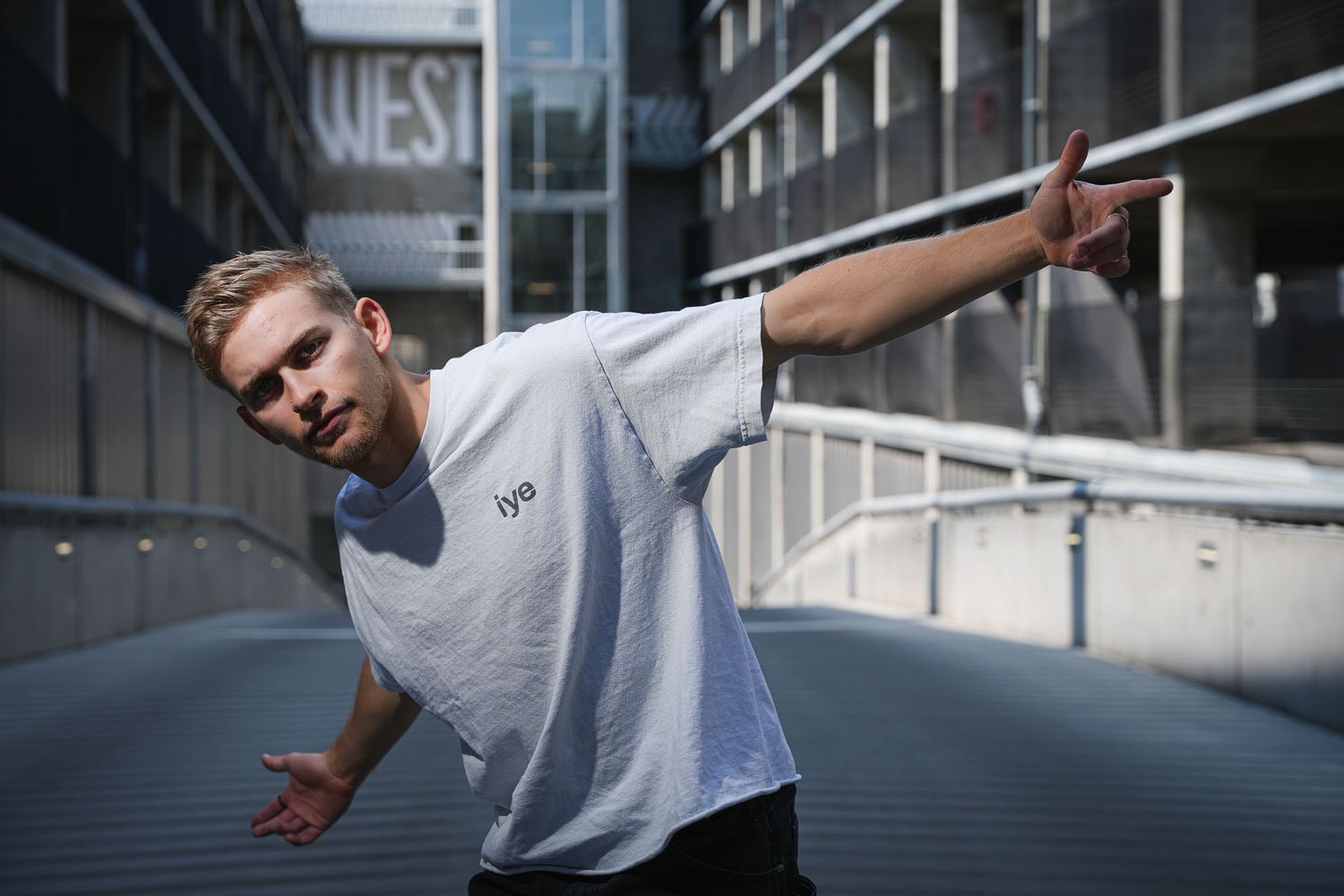 Person demonstrates fluid movement sequence along modern building exterior.