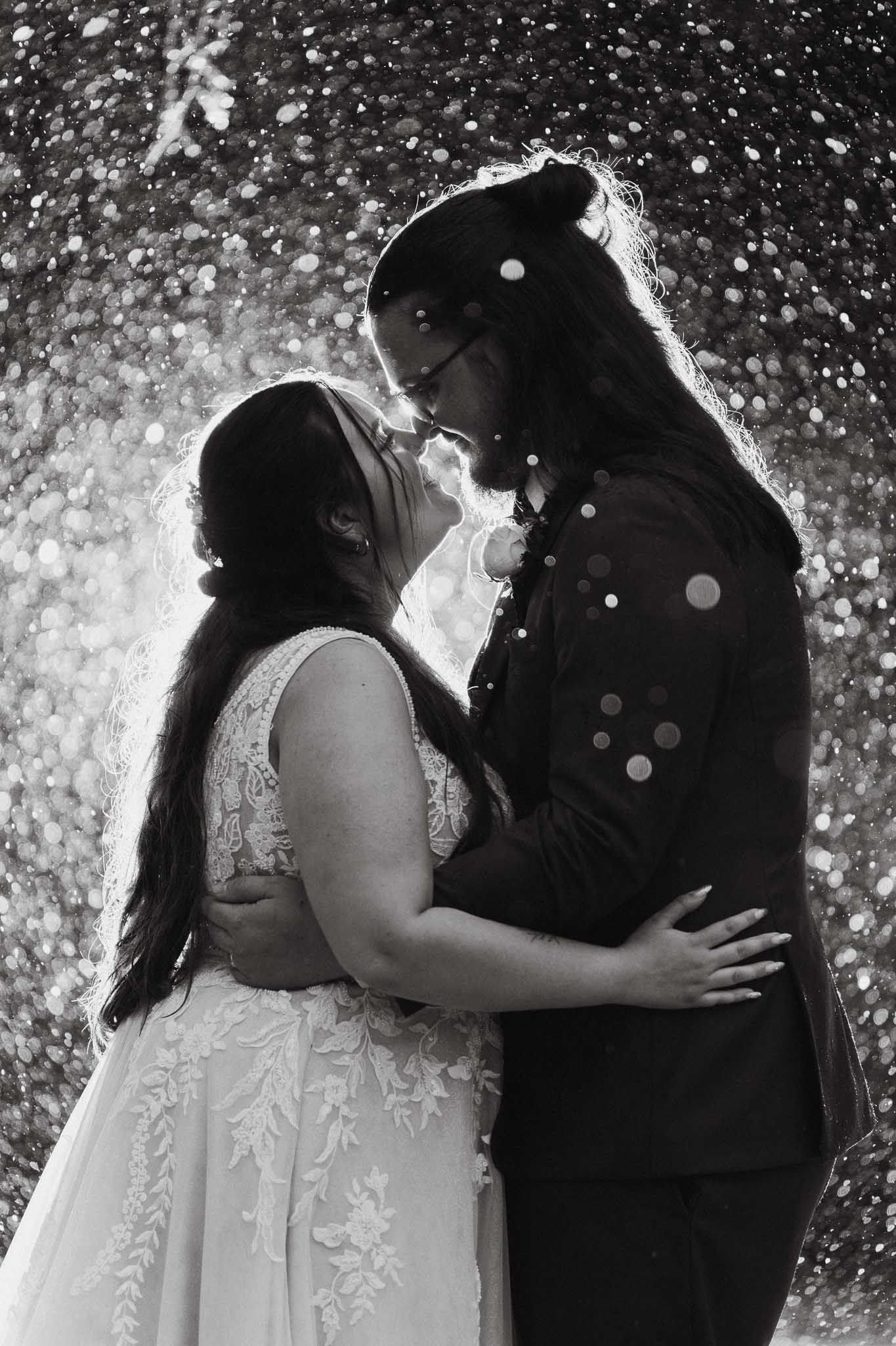 Black and white sequence of romantic moments with sparkles and bokeh effects.