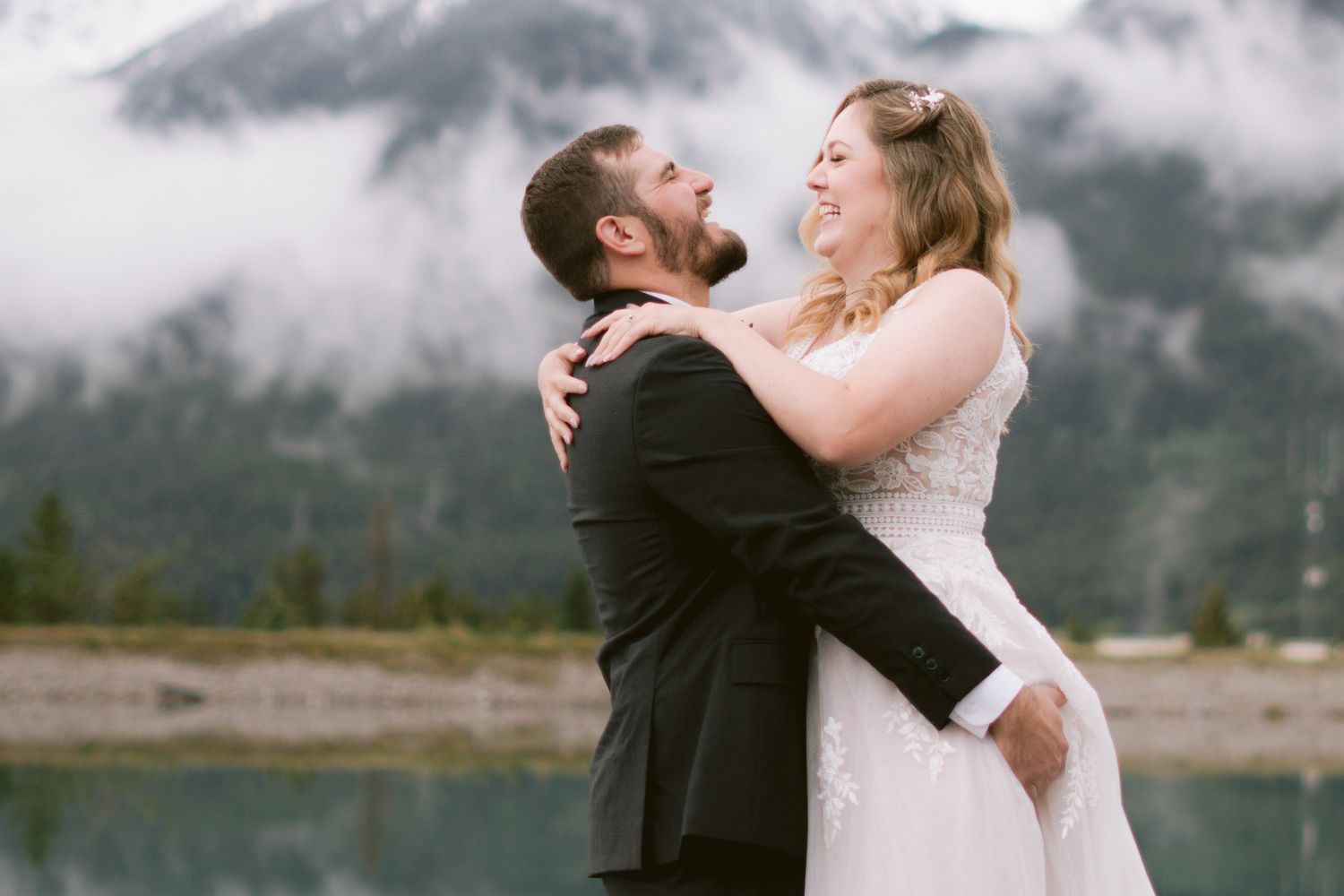 Romantic couple portraits against misty mountain landscape in Canmore, Alberta