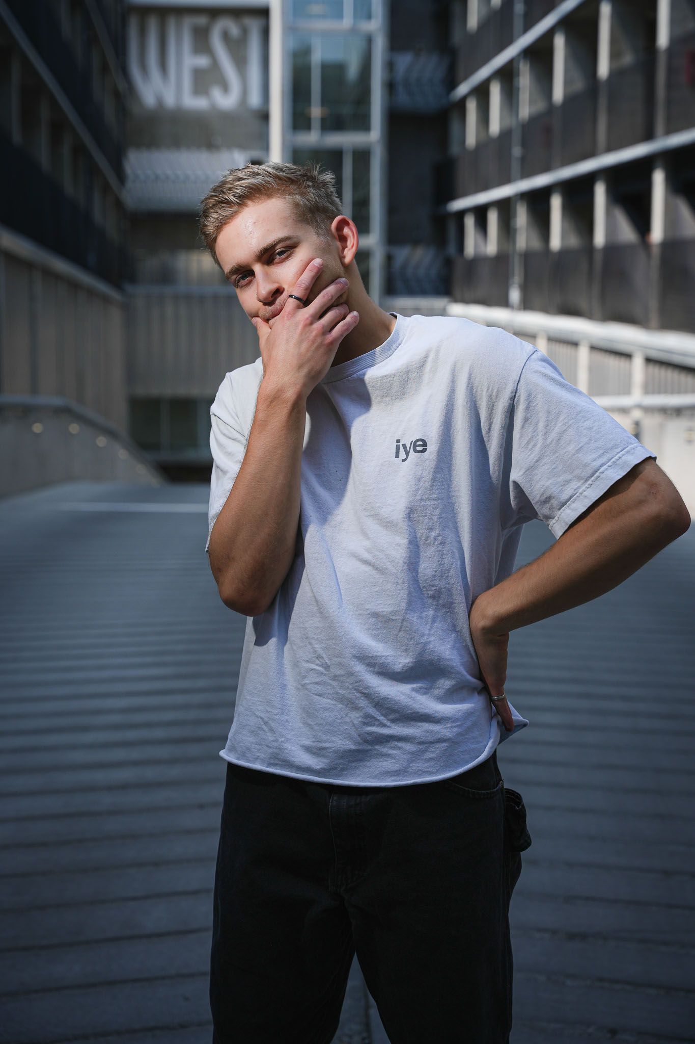 Portrait series showing emotive poses against modern urban architecture.