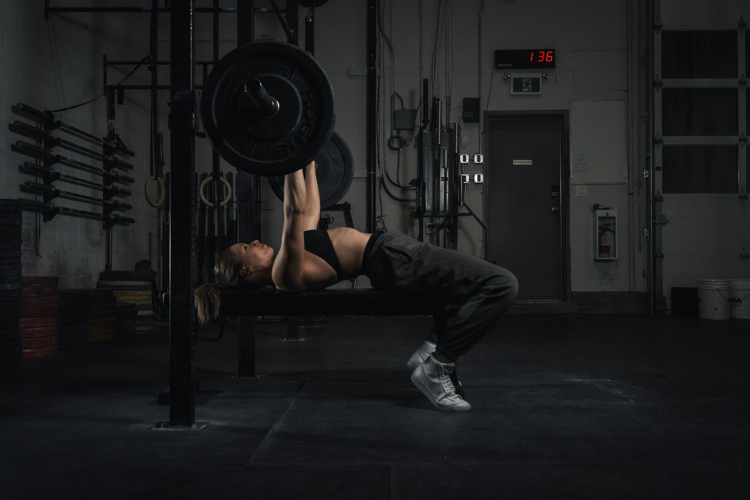 Dark atmospheric shot of workout equipment and exercise space in a gym.