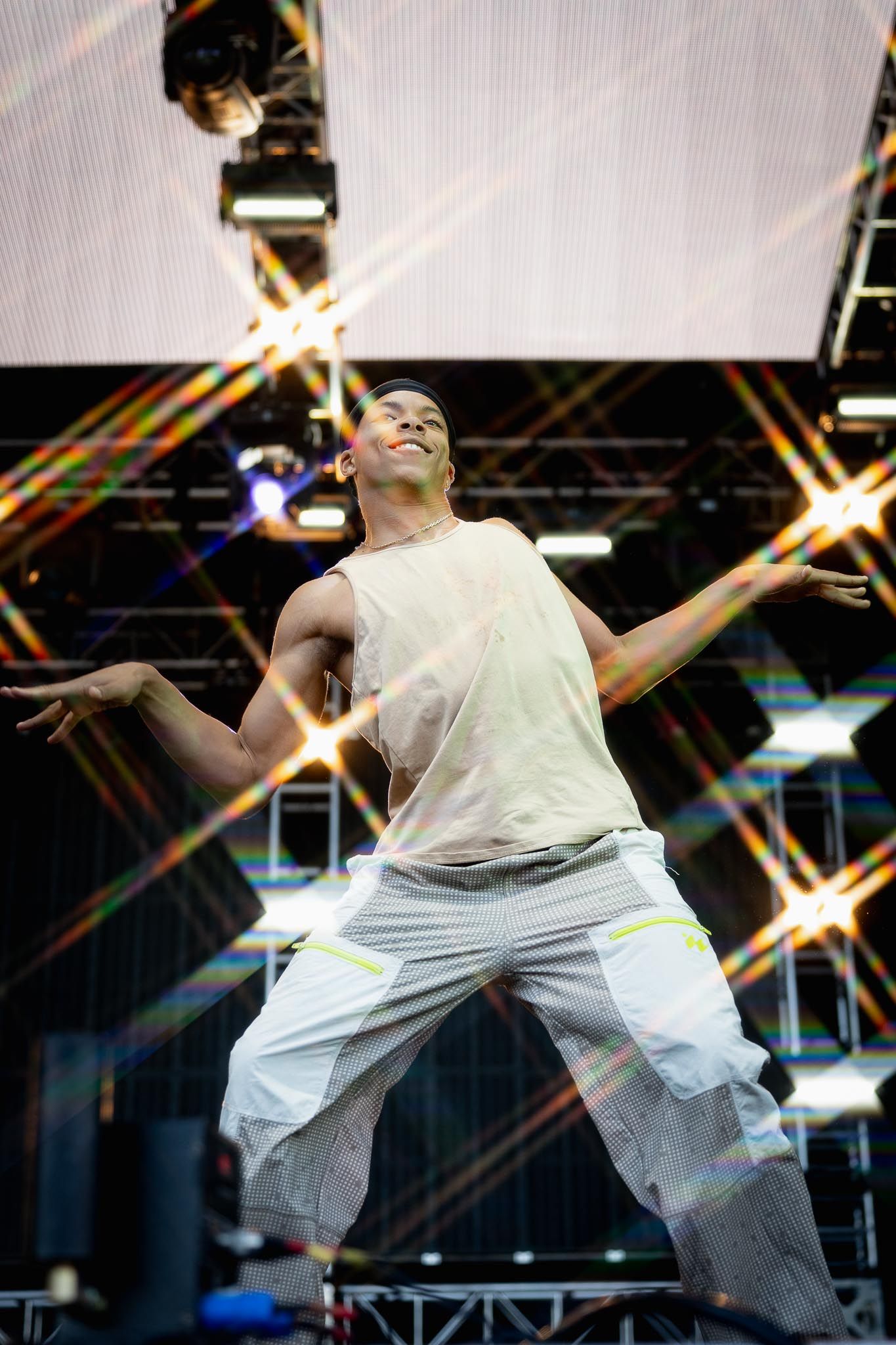 Energetic dance performance on stage with dramatic star-shaped lighting effects in background.