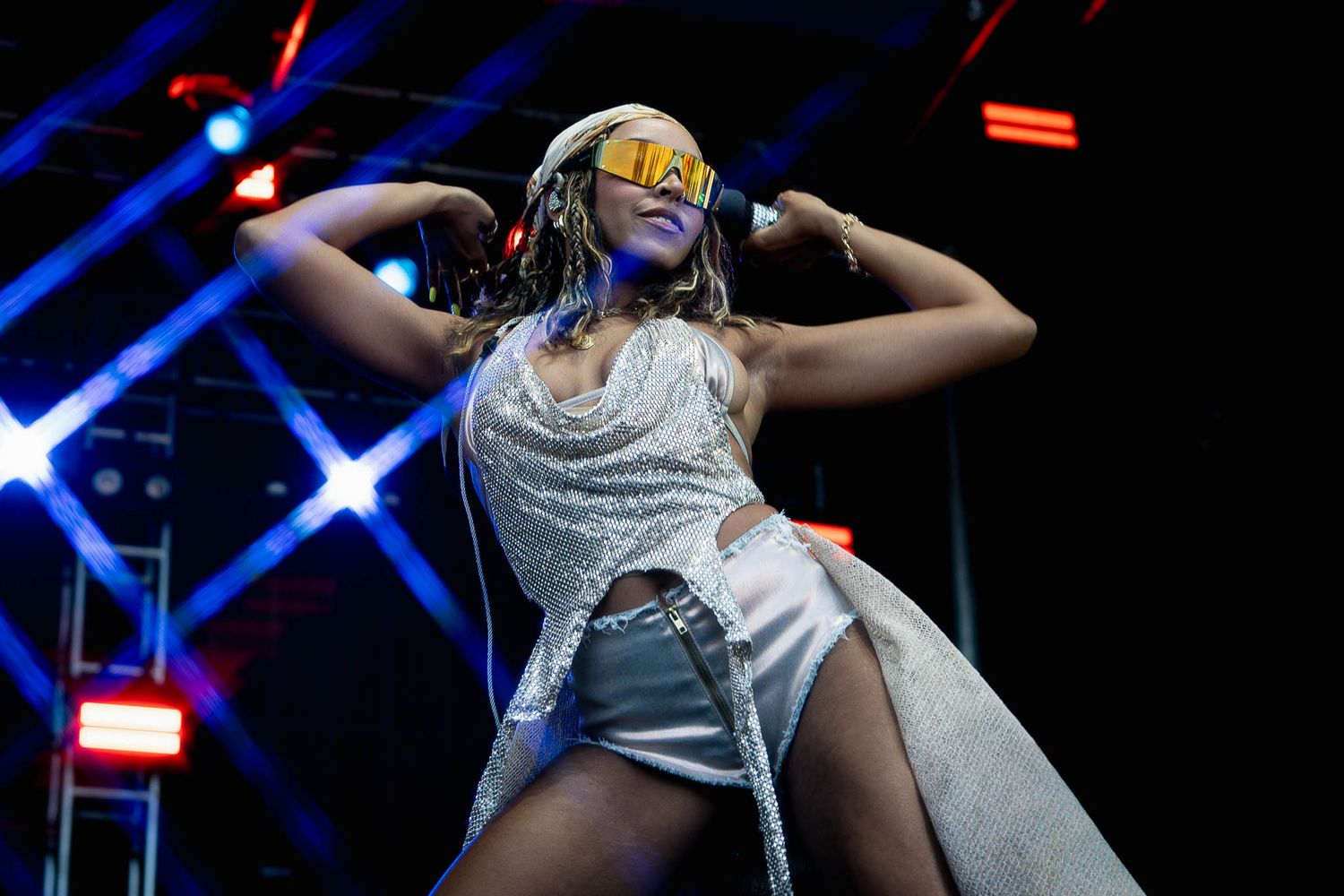 Dancers perform energetic routine on stage with dramatic blue lighting effects.
