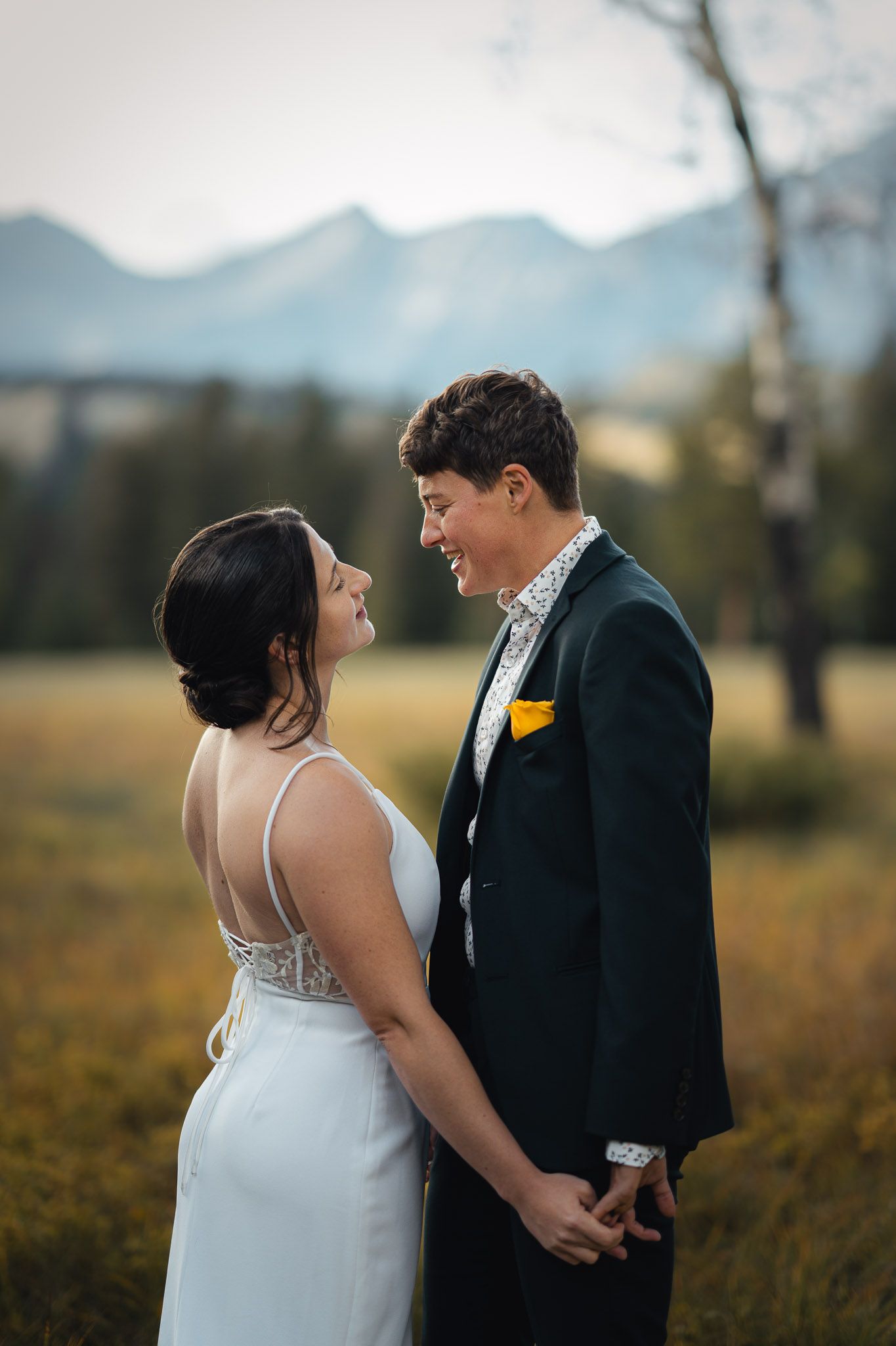 Intimate wedding portraits with mountain scenery and autumn colors in the background in Jasper, Alberta