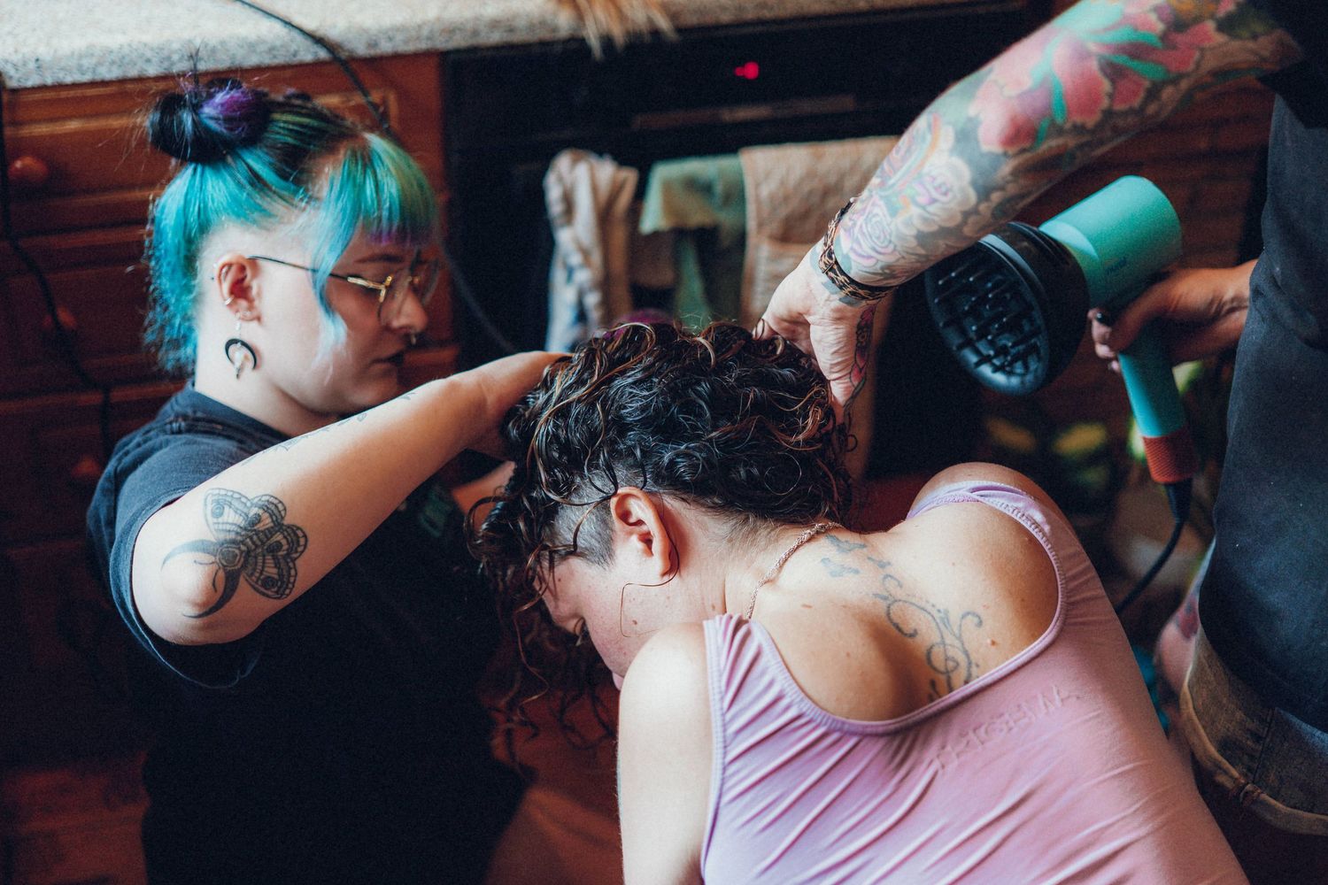 Close-up of colorful tattoos and decorative details at a wedding celebration.