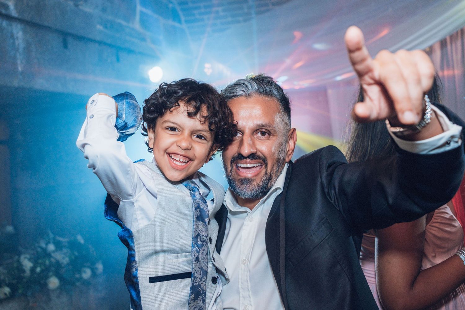 Celebratory moments captured at a wedding reception with guests enjoying the festivities.